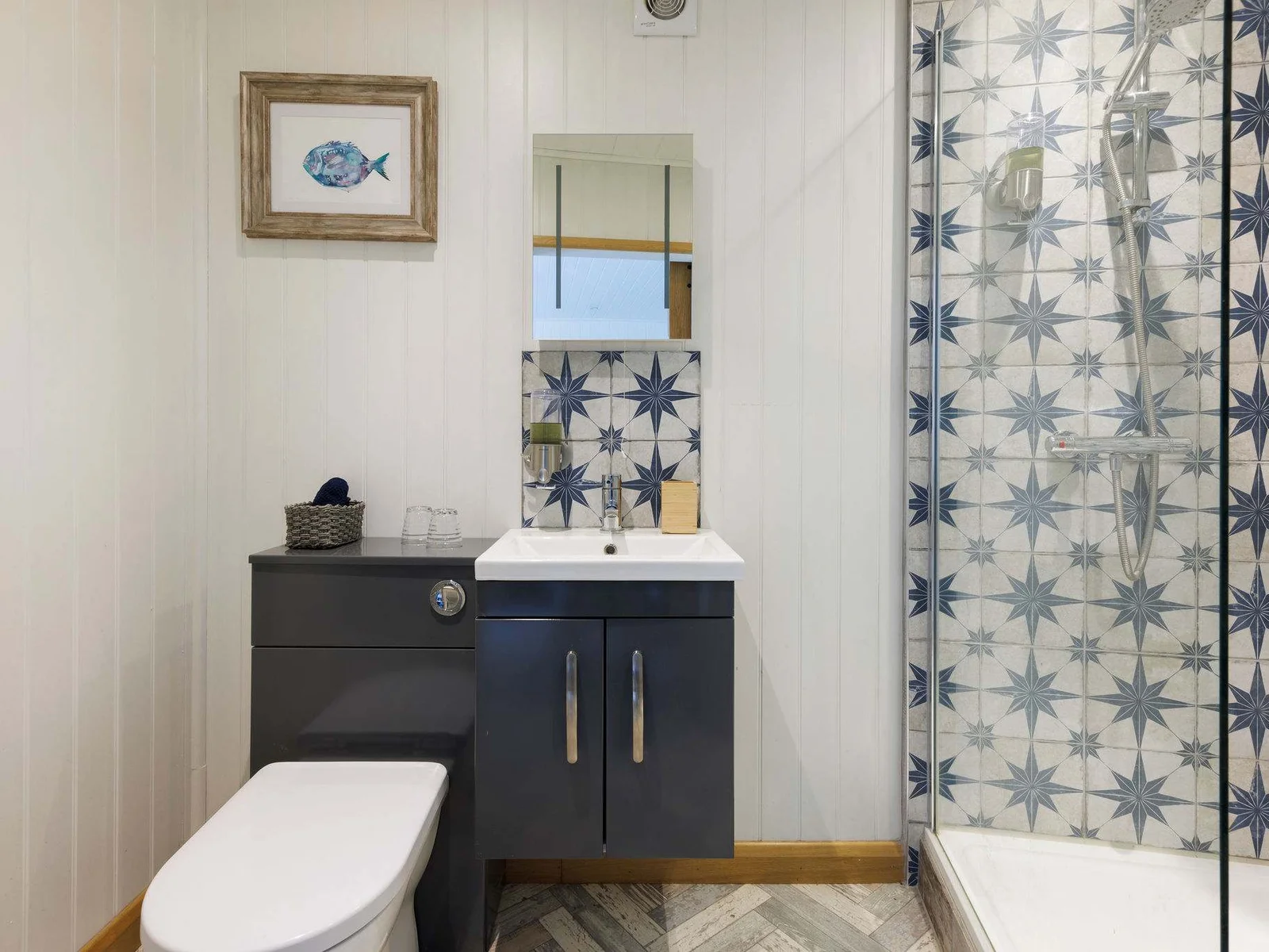 The surprisingly spacious ensuite bathroom features a huge walk-in shower, large mirror, WC and sink.