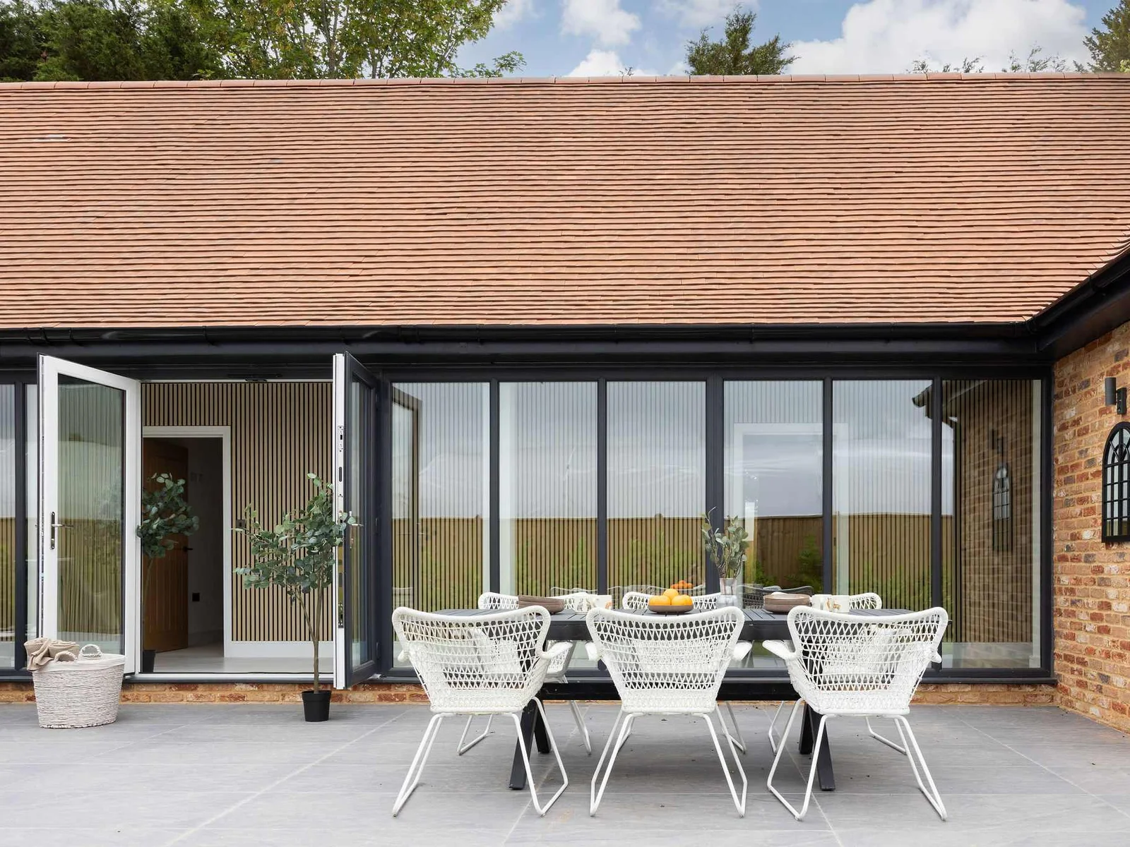 Outdoor dining area with comfortable seating and garden access