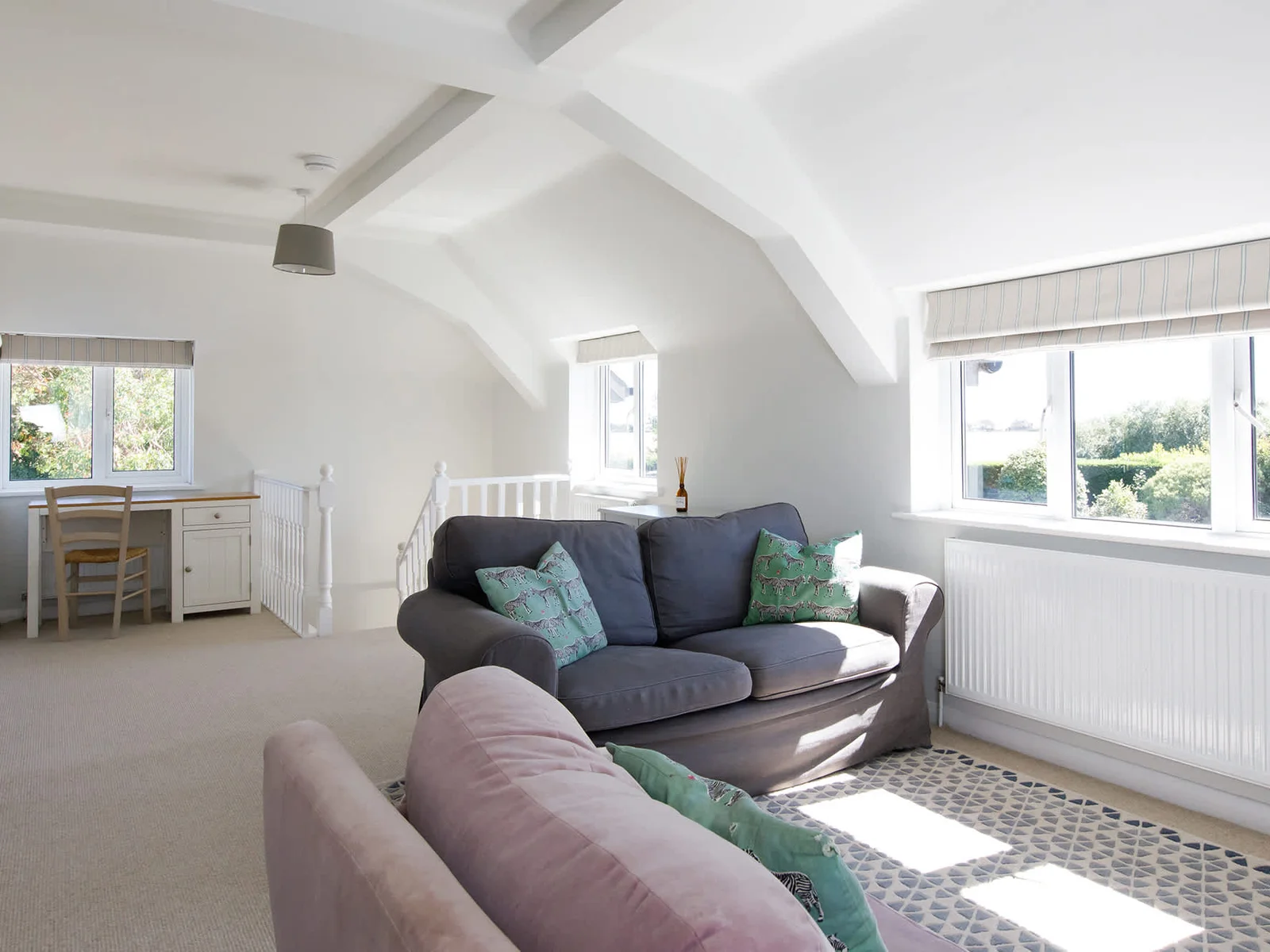 The impressive landing area offers a further snug area with sofas and TV, as well as desk space.