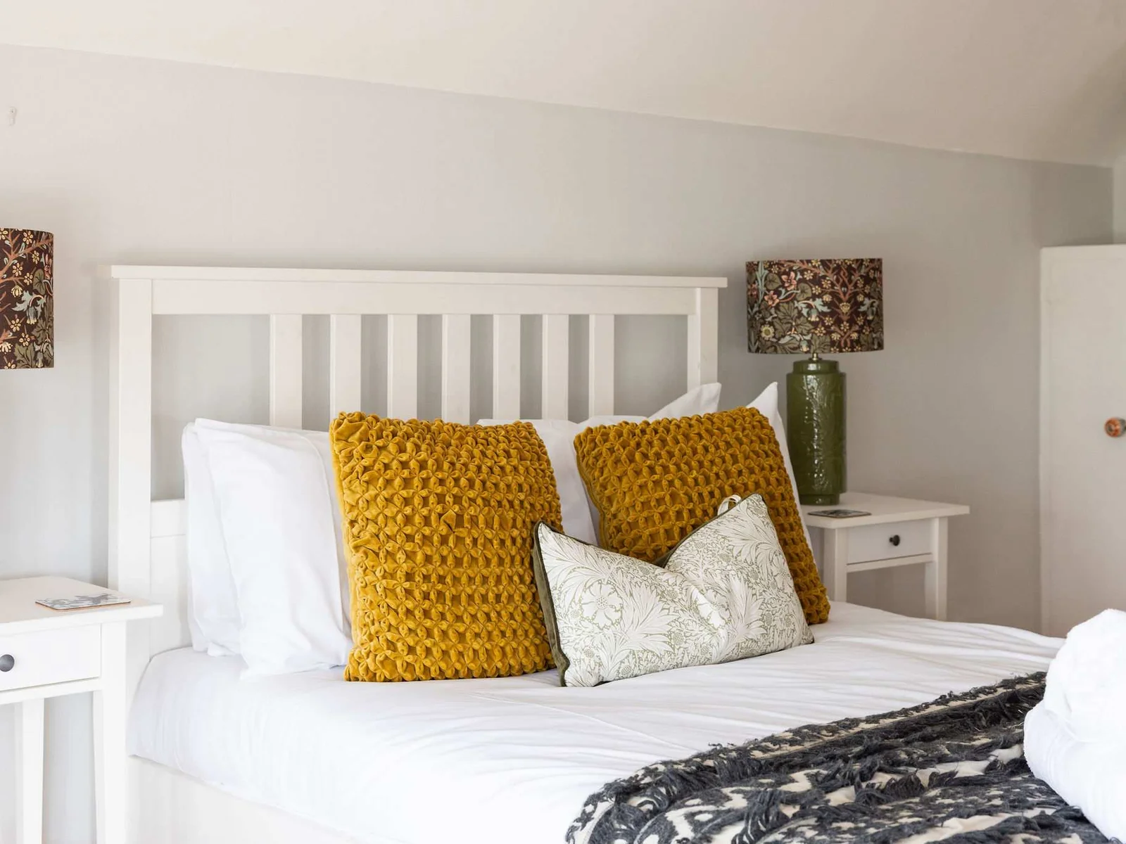 Lush cushions and throws enhance the comfort of this bedroom.