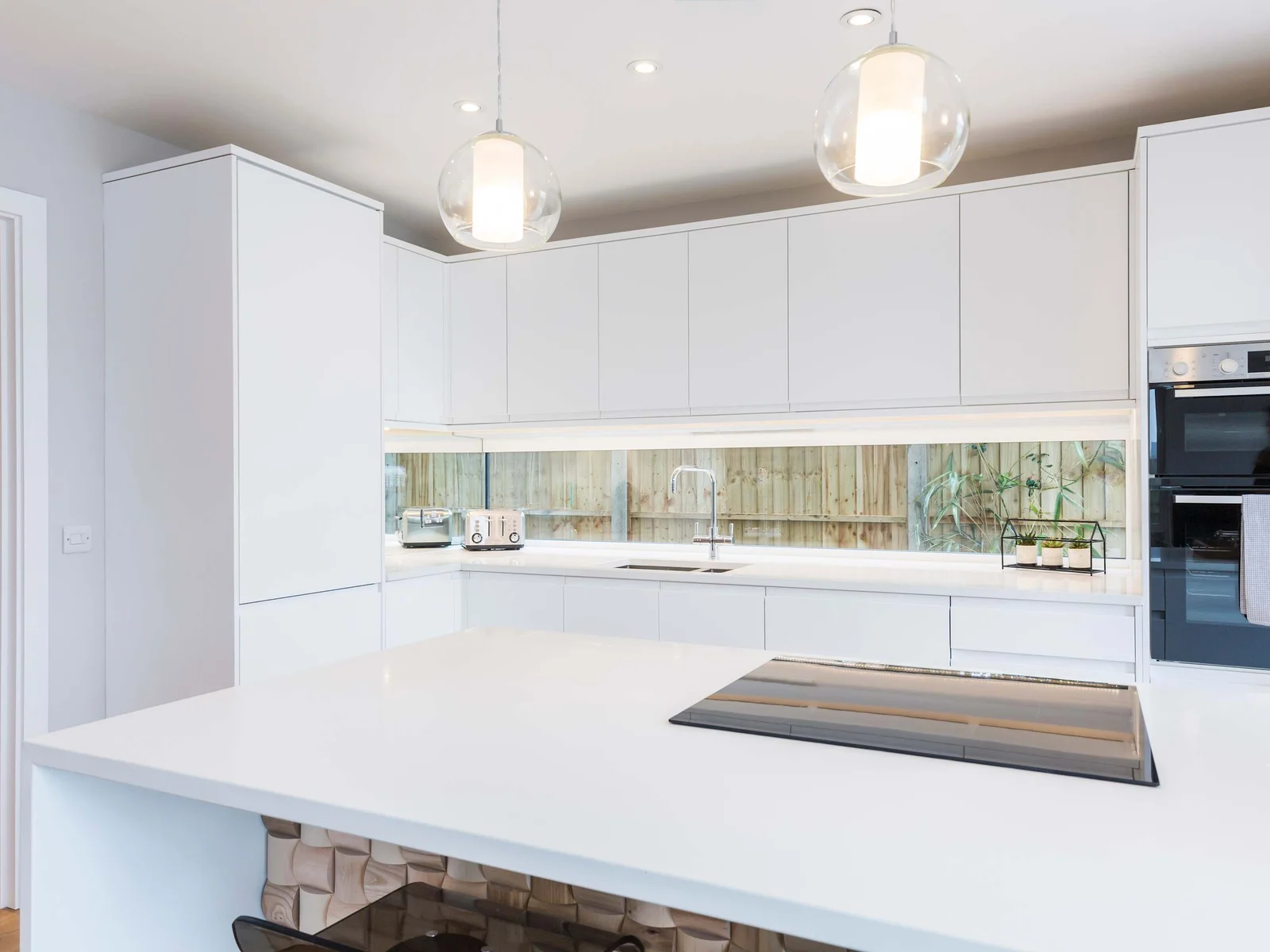 How's this for a stylish kitchen with sleek white cabinets?