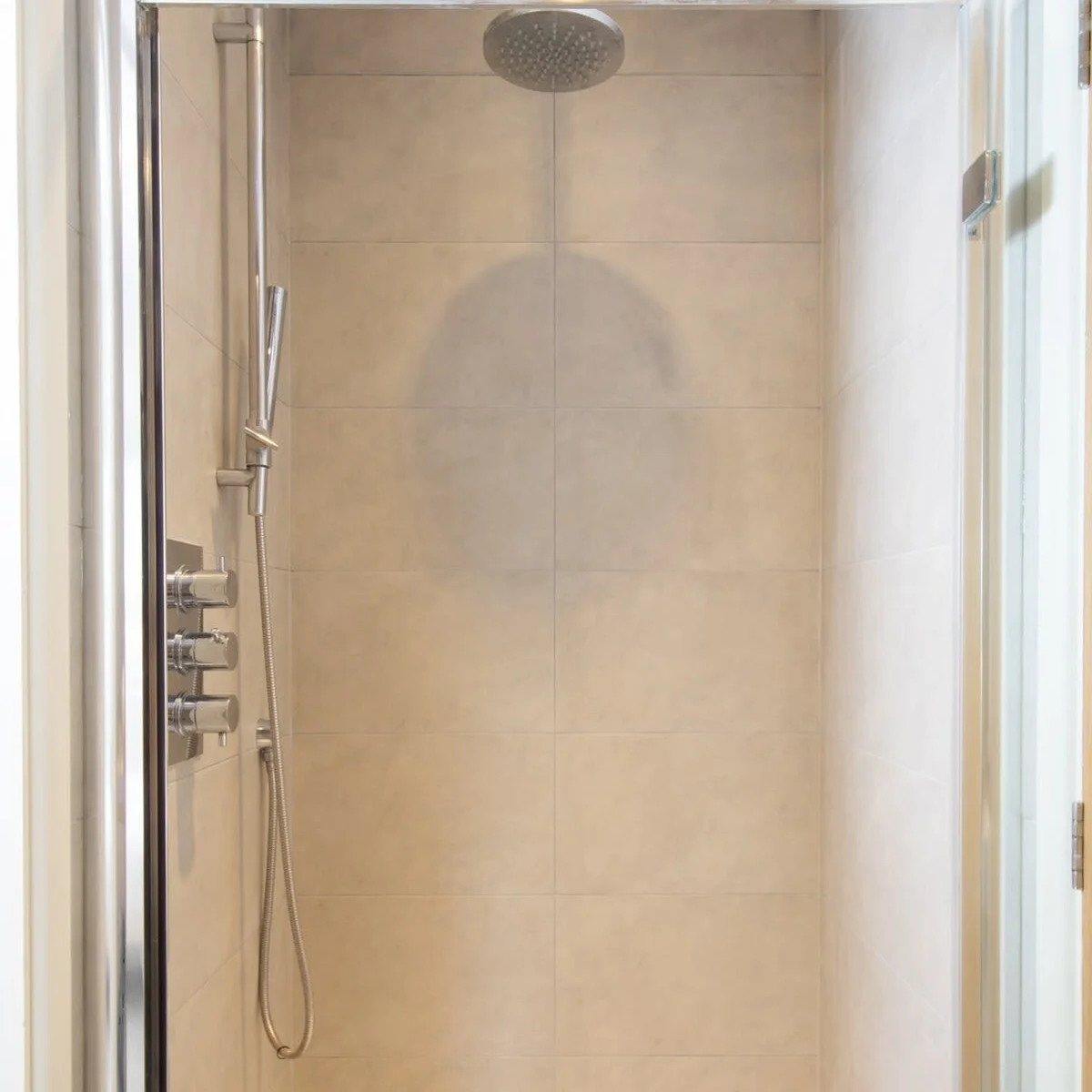 The second bathroom has a modern shower unit