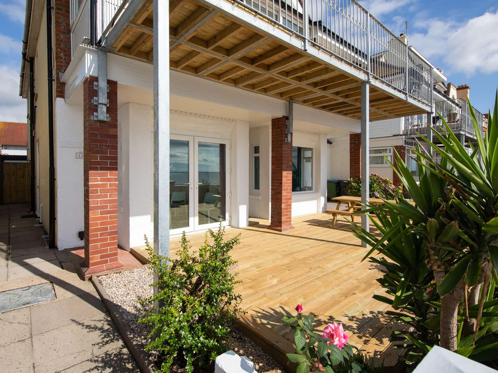 Surrounded by lush gardens, the front deck is perfect for entertaining