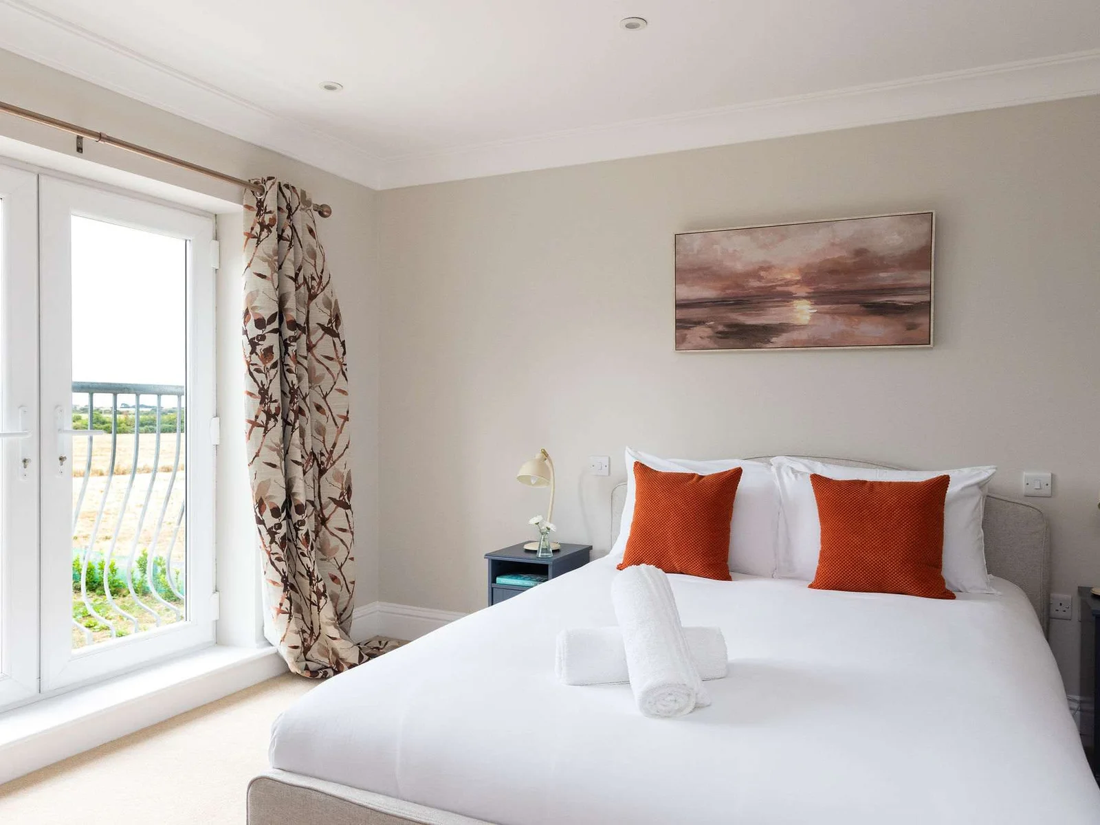 Wake up to countryside views from the master bedroom, with French doors that make the room feel wonderfully open and connected to the rural setting outside.