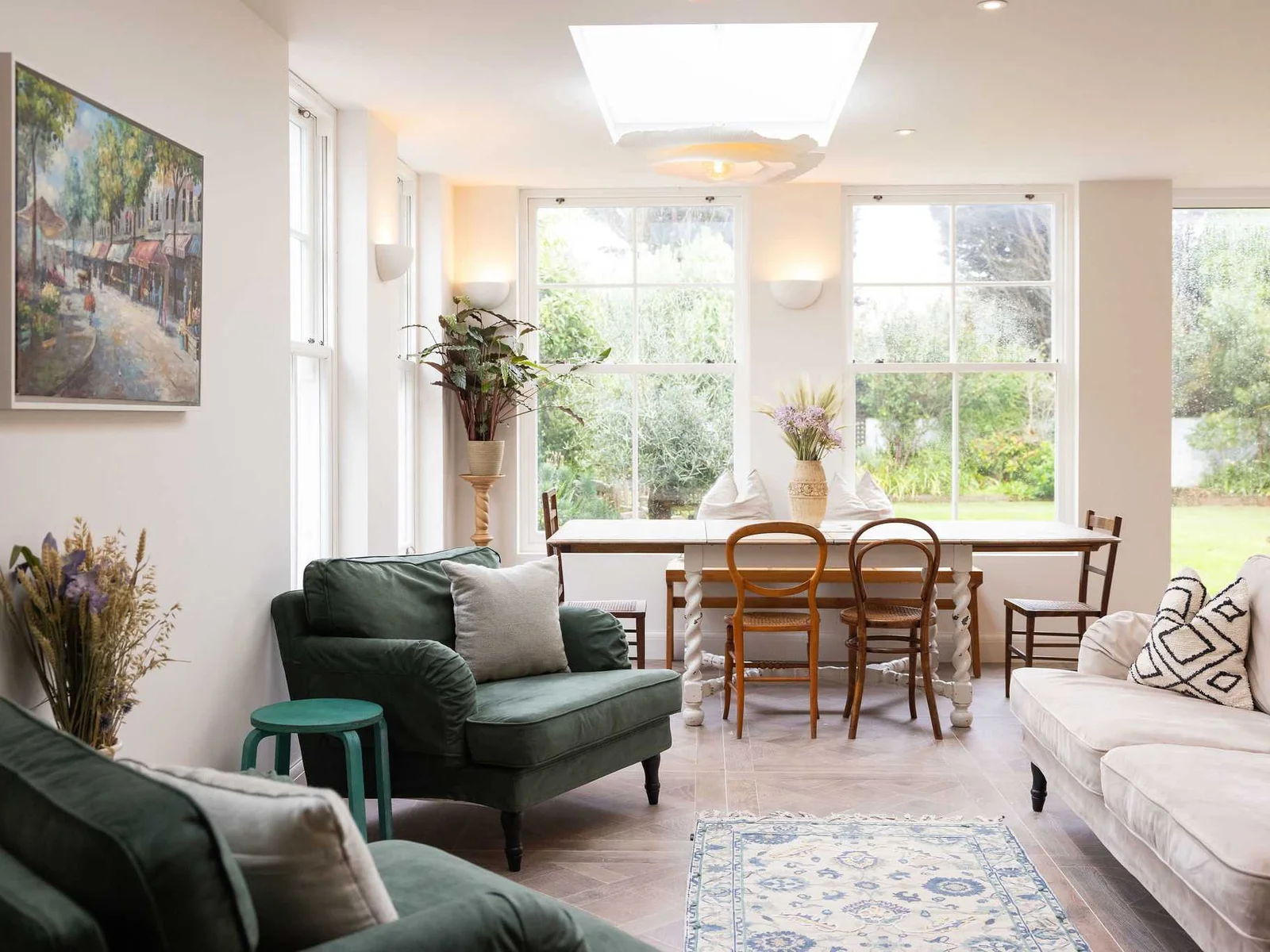 Sunlit living and dining with comfy seating and beautiful views of the private garden.