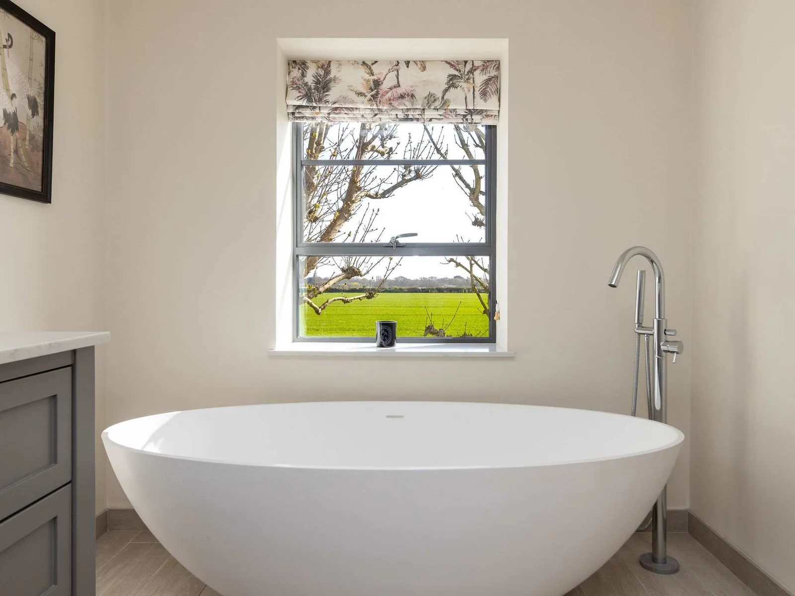 Soak in the stunning freestanding tub while enjoying peaceful countryside views through the window.