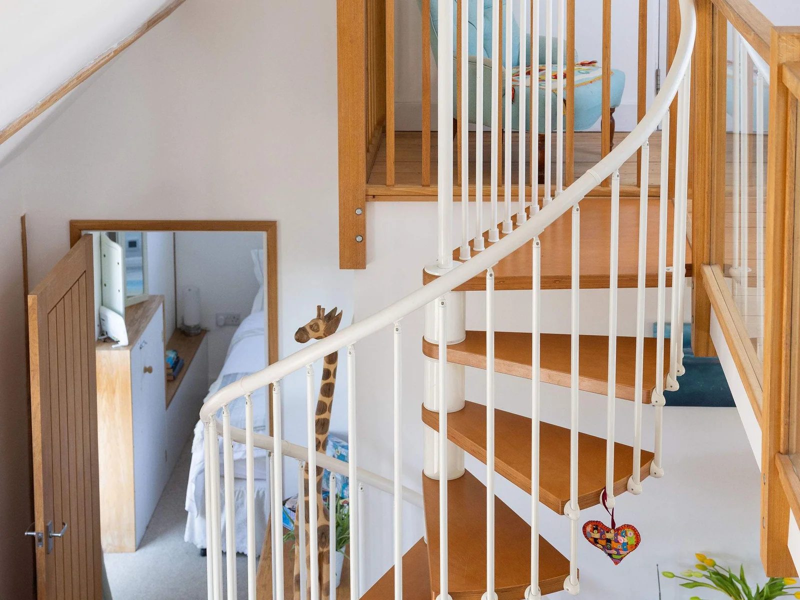 The spiral staircase in the barn leads up to a mezzanine living area.