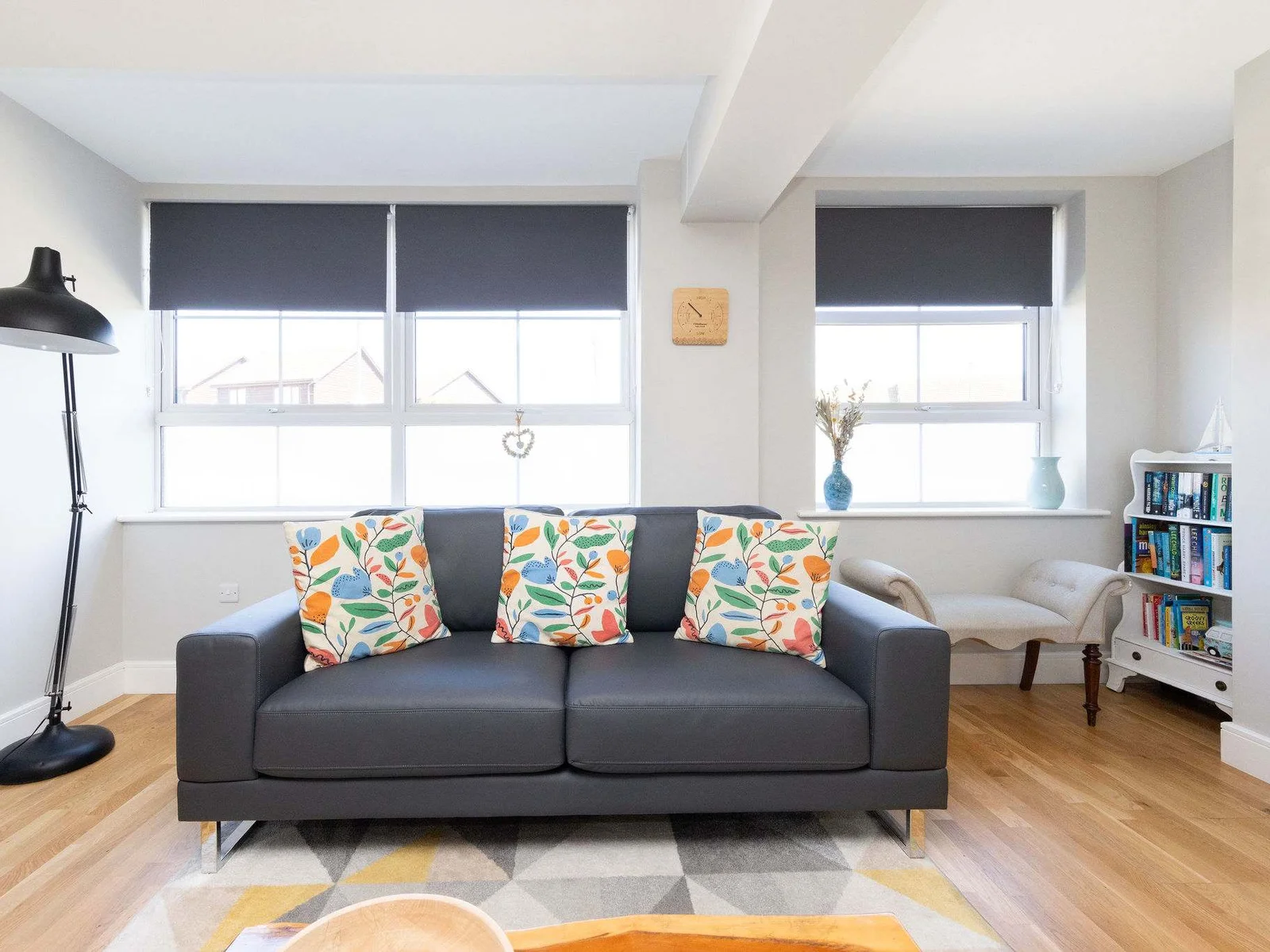 Comfortable lounge with bright natural light, perfect for a relaxing seaside holiday home