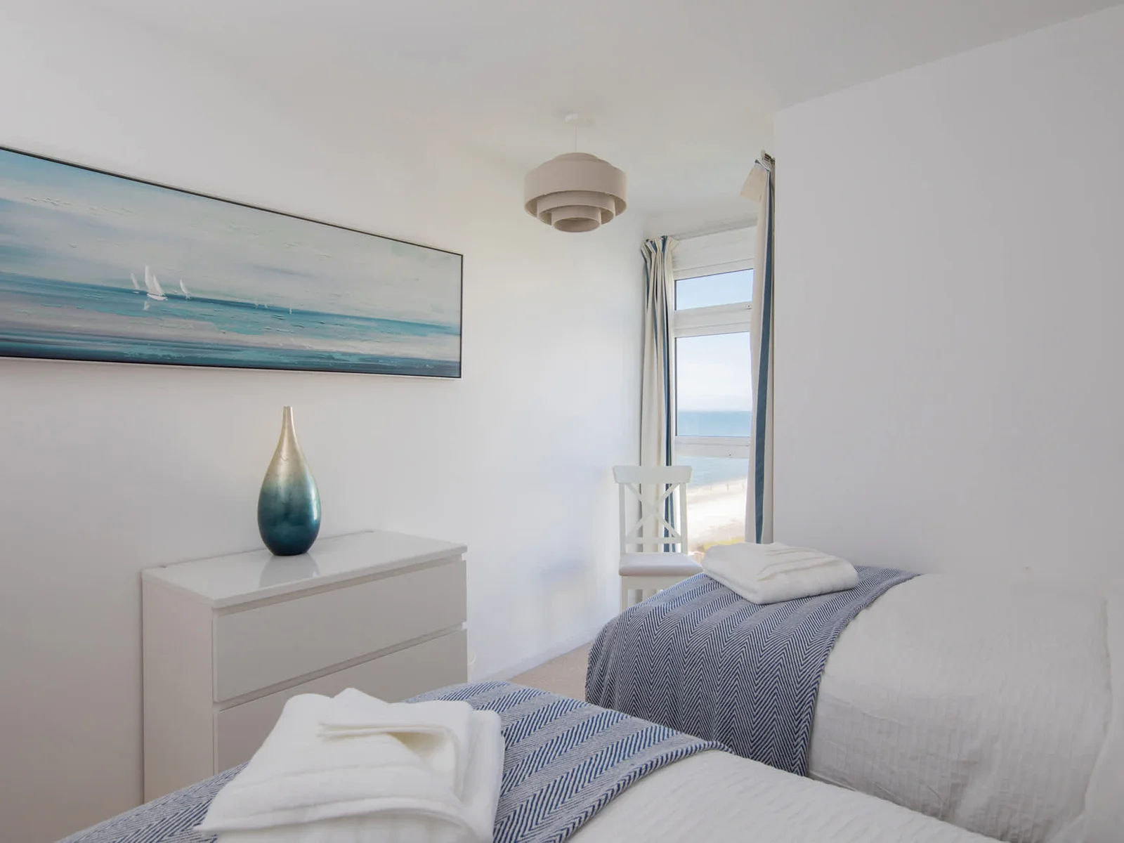 The second bedroom offers two comfortable twin beds and sea views from the floor to ceiling window!