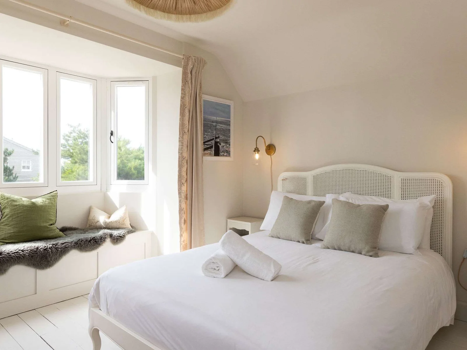 This king bedroom, complete with window seat, is beautifully furnished and decorated.