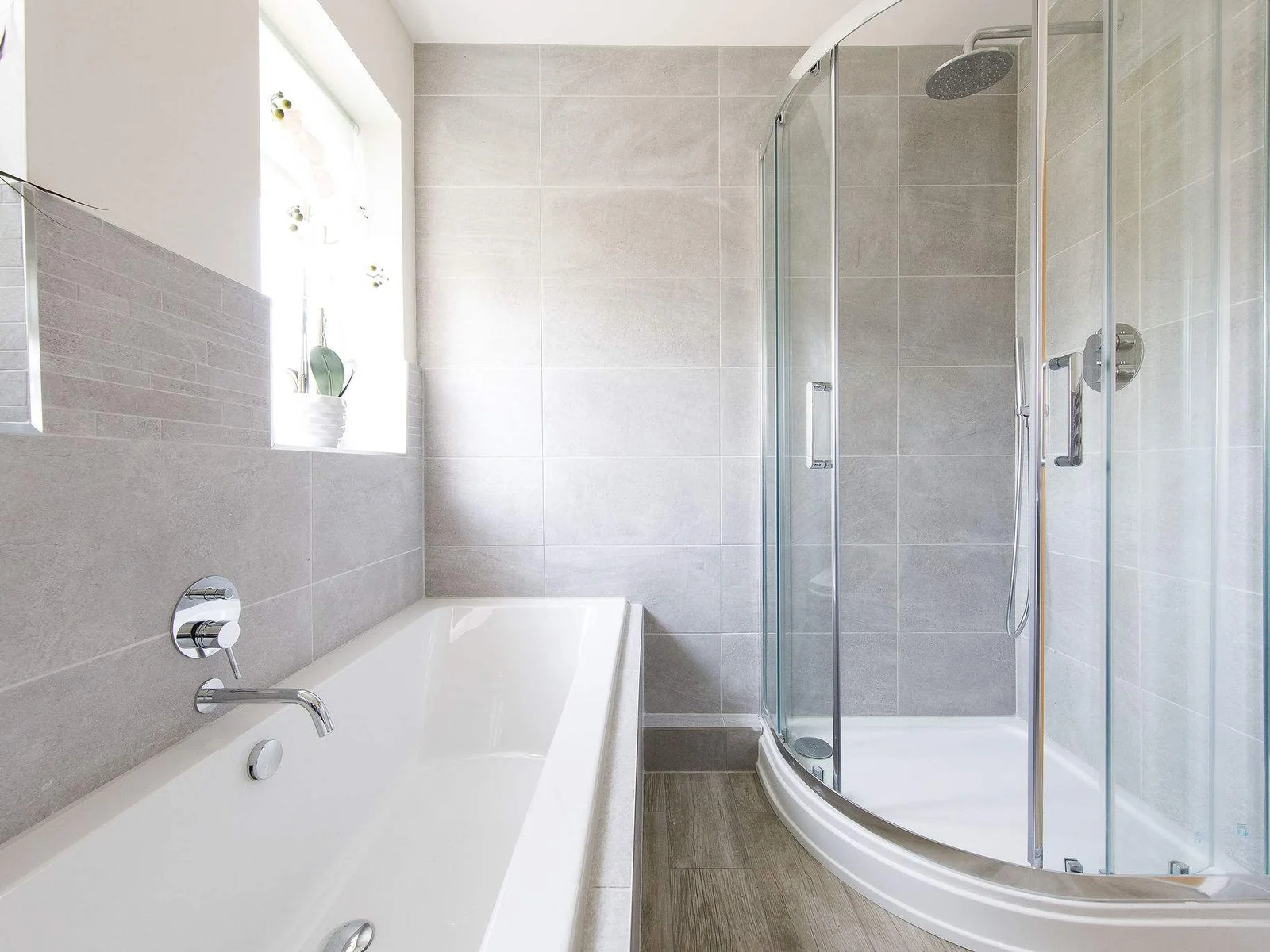 The modern family bathroom has a bath, separate shower, WC and sink.
