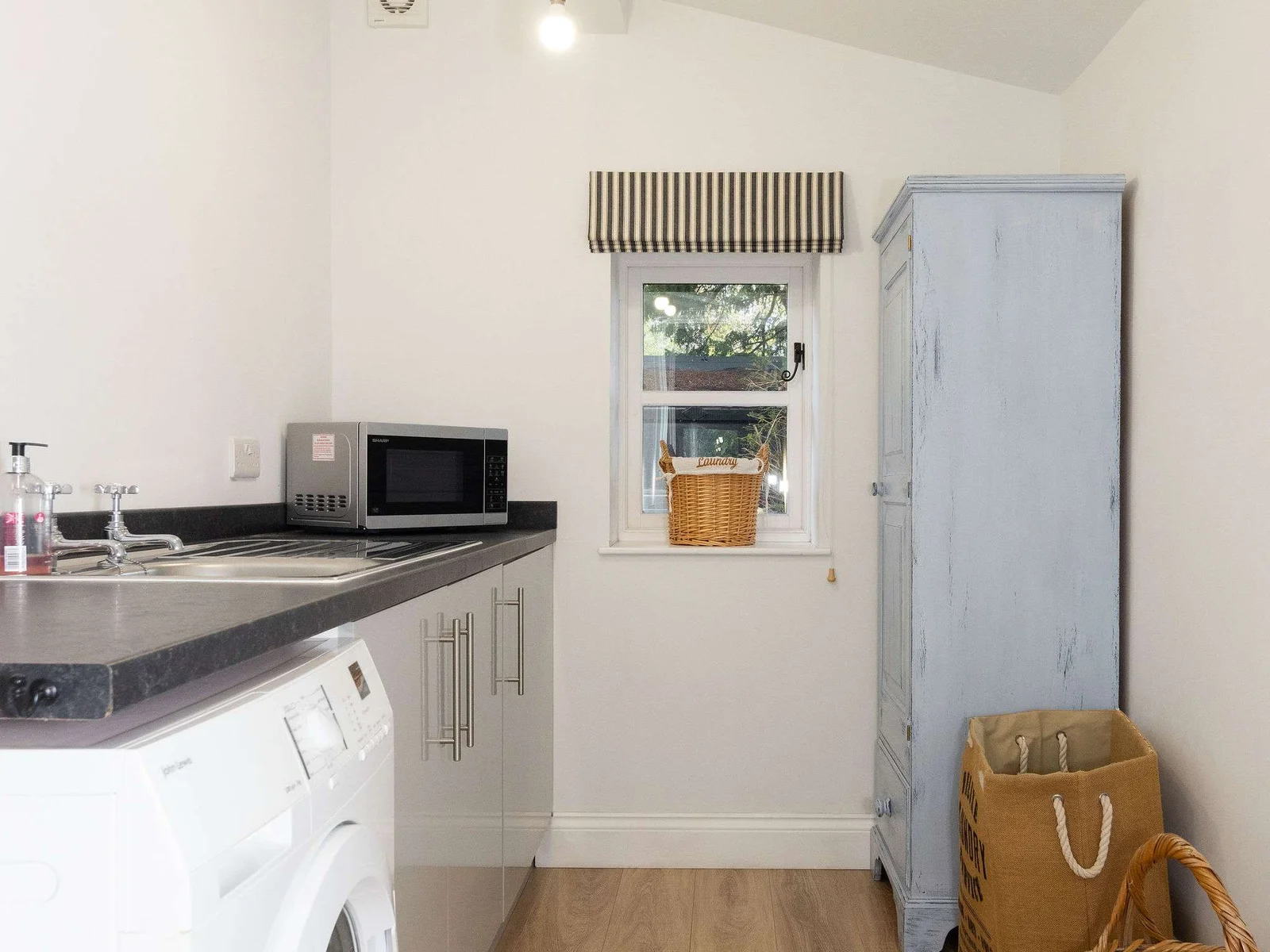 Utility room with washer and sink