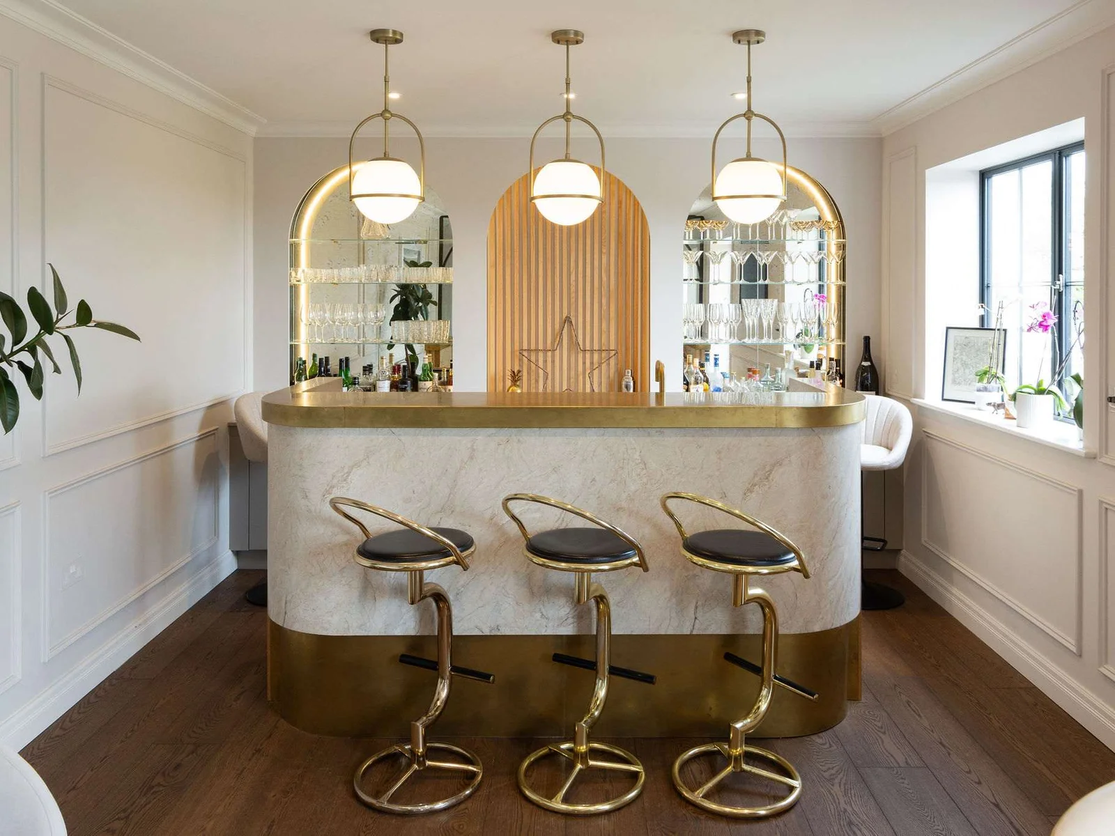 Retire to the elegant marble bar with gold finishes and mirrored backdrop