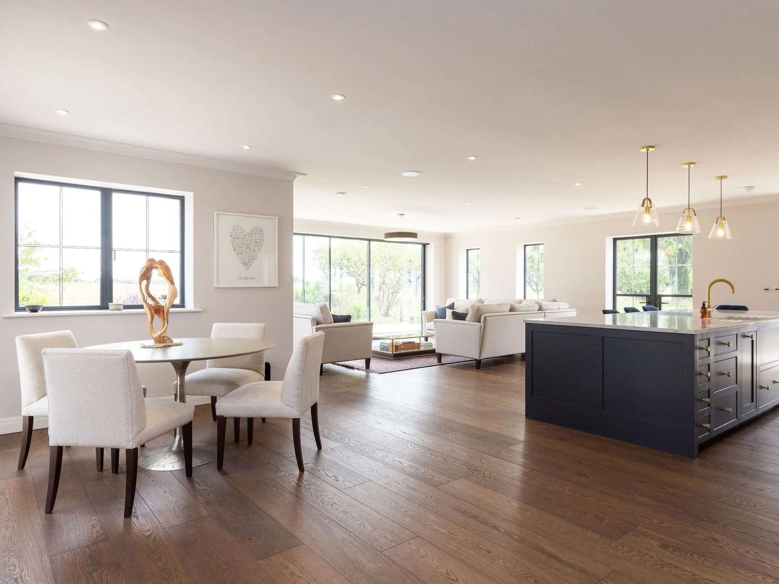 Elegant open-plan kitchen, dining and living space flooded with natural light