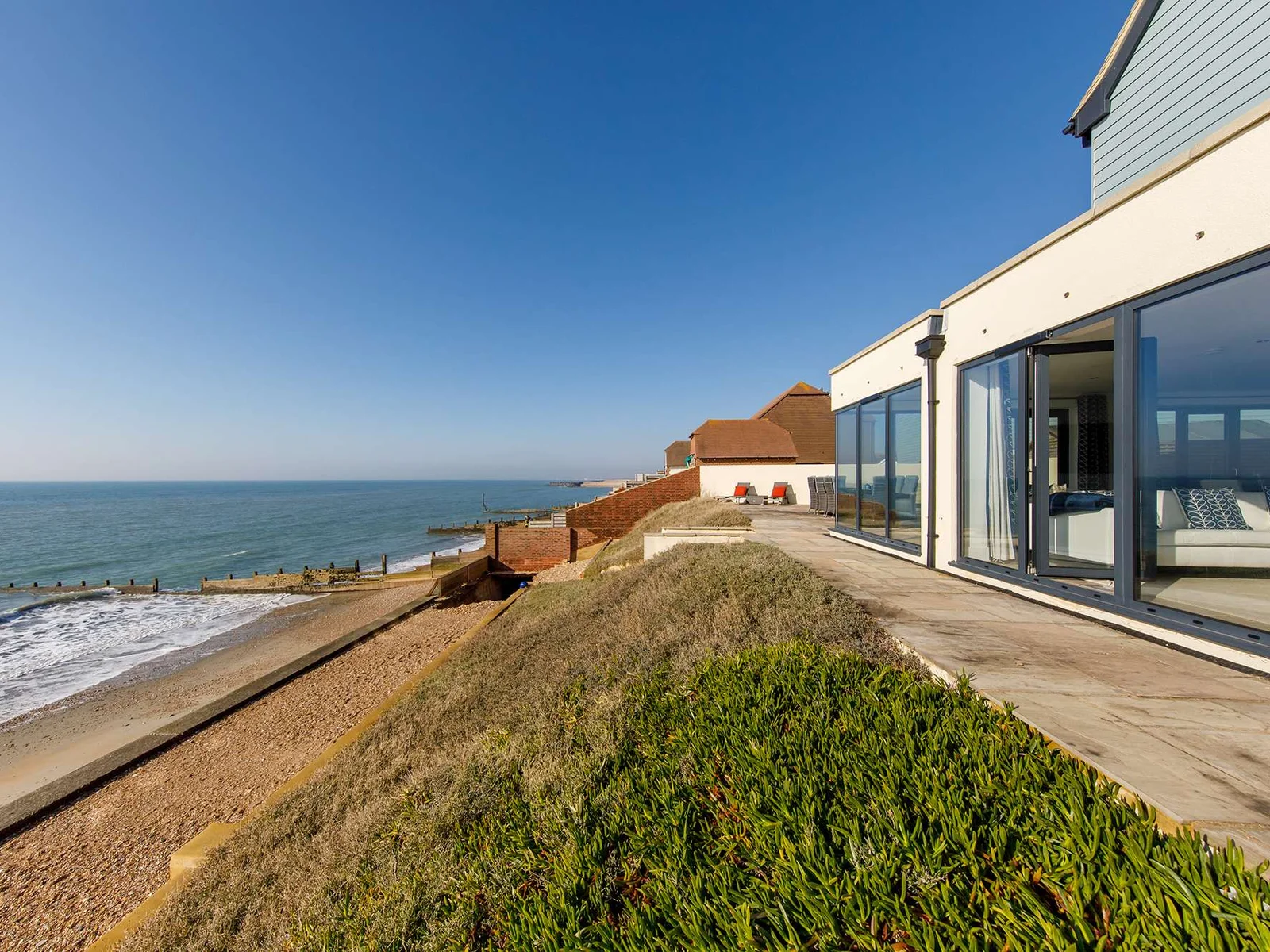 Open the living room doors and let the warm sea air drift in.