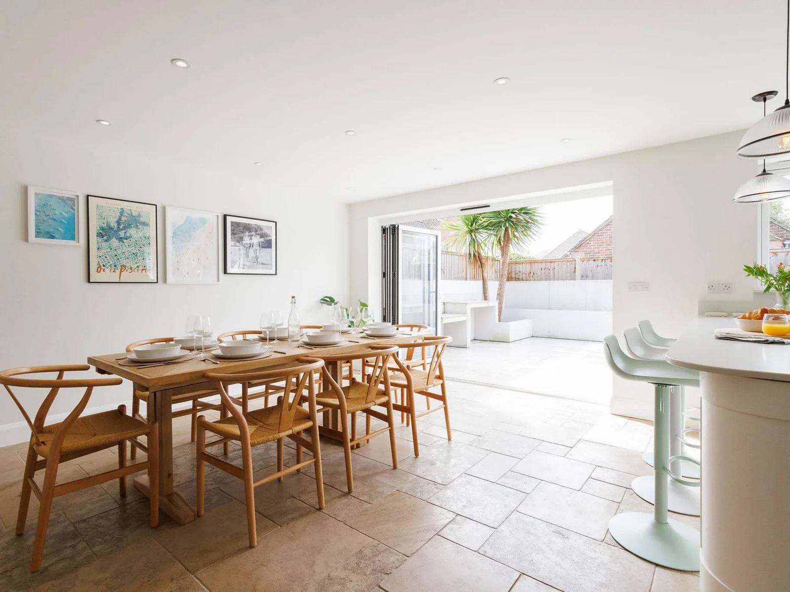 Open plan kitchen/dining area with bi-fold doors to the serene outdoor area.