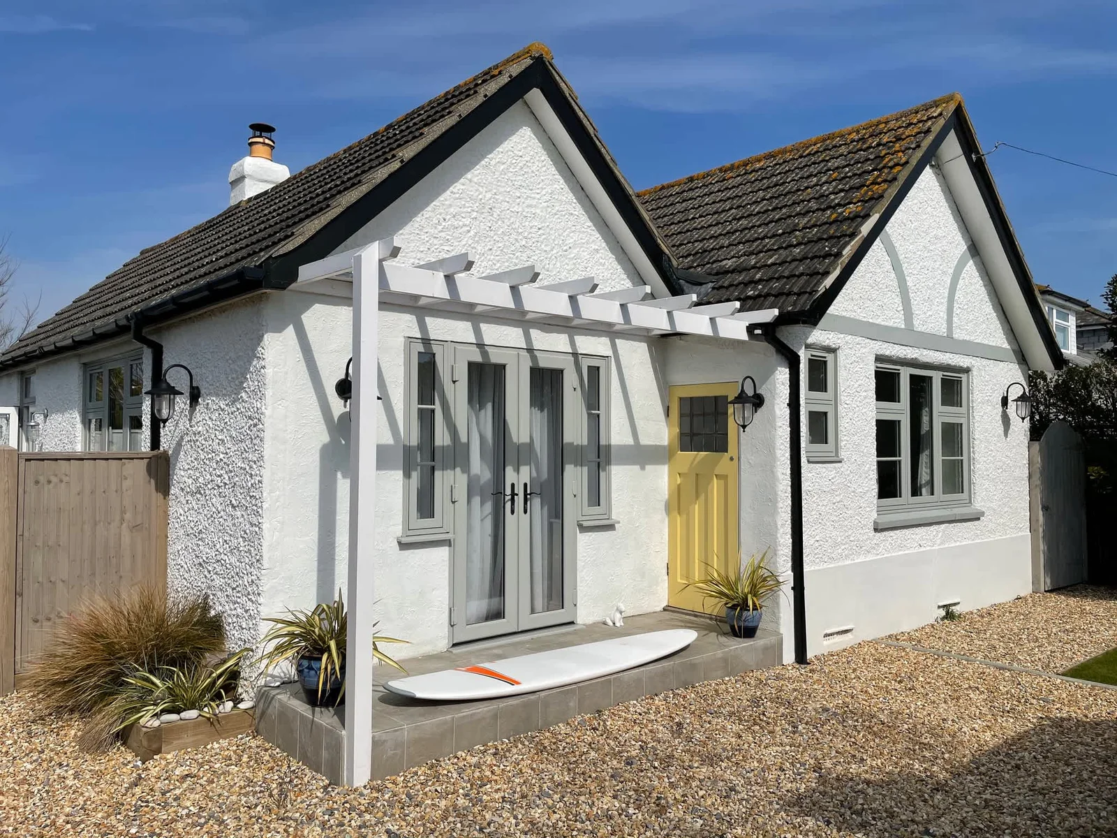 Beach Holme Exterior View with vibrant yellow door.