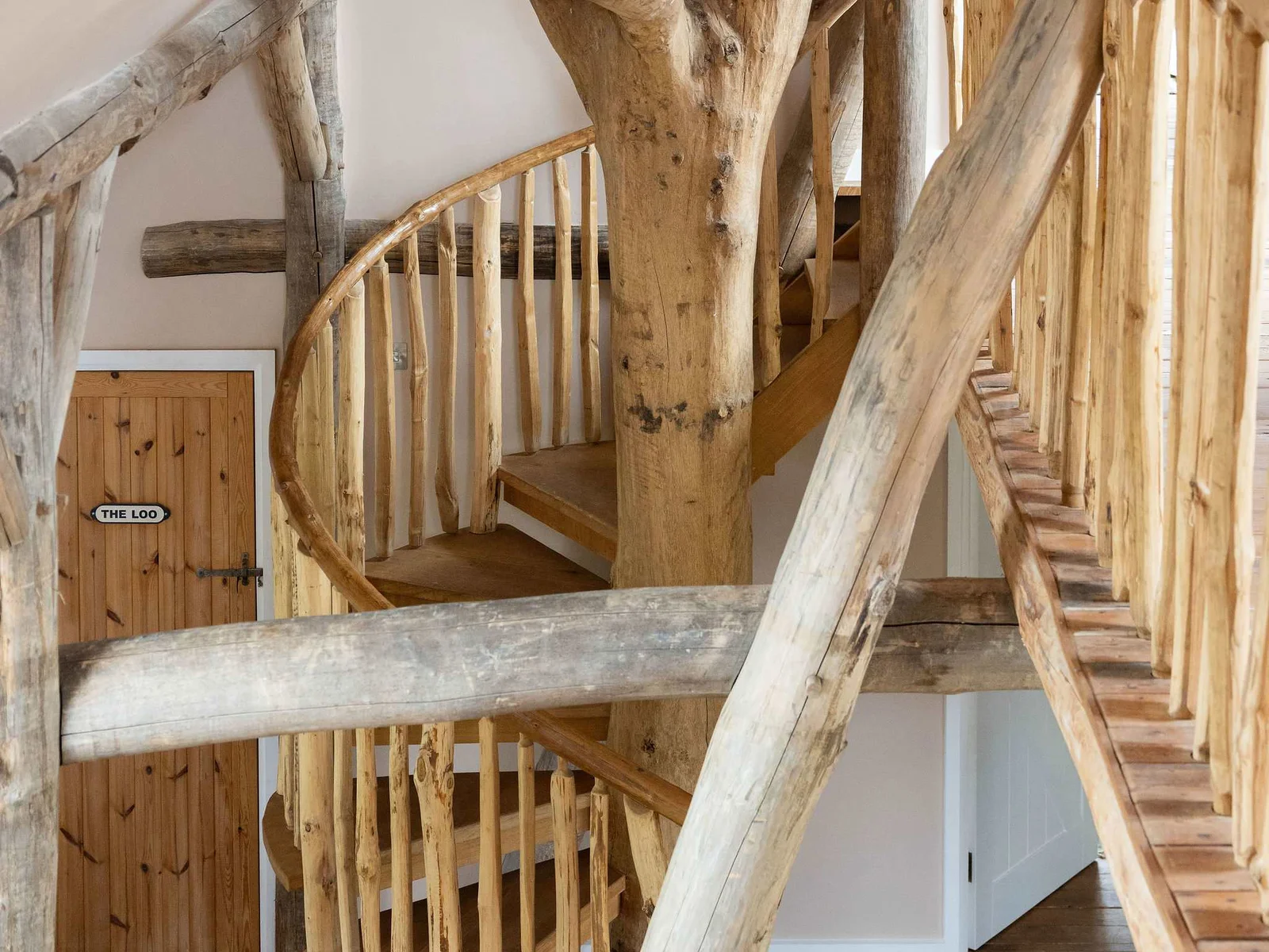 A staircase like no other — handcrafted woodland artistry at the heart of the lodge.