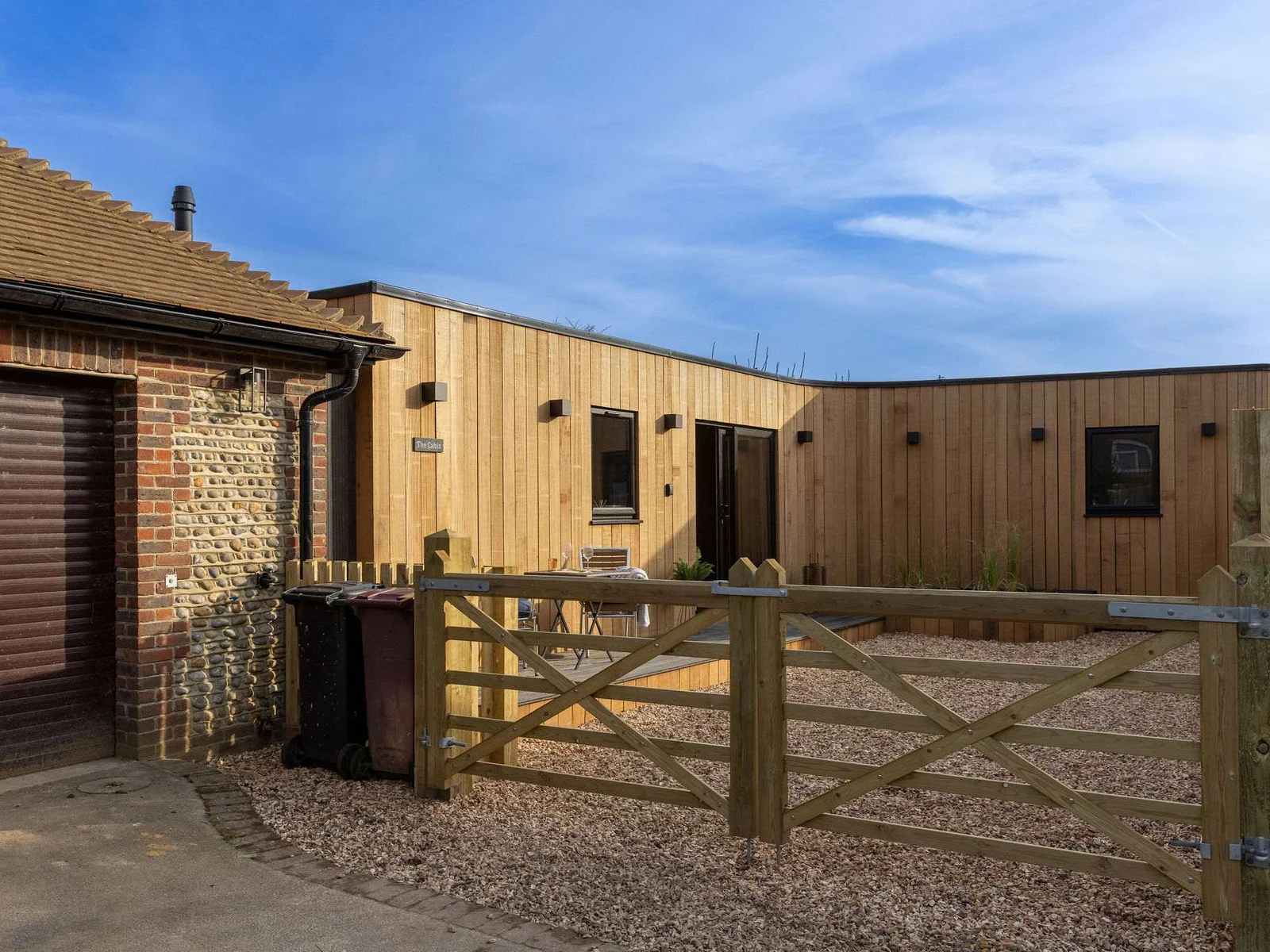The gated driveway offers a safe space for both dogs and children.