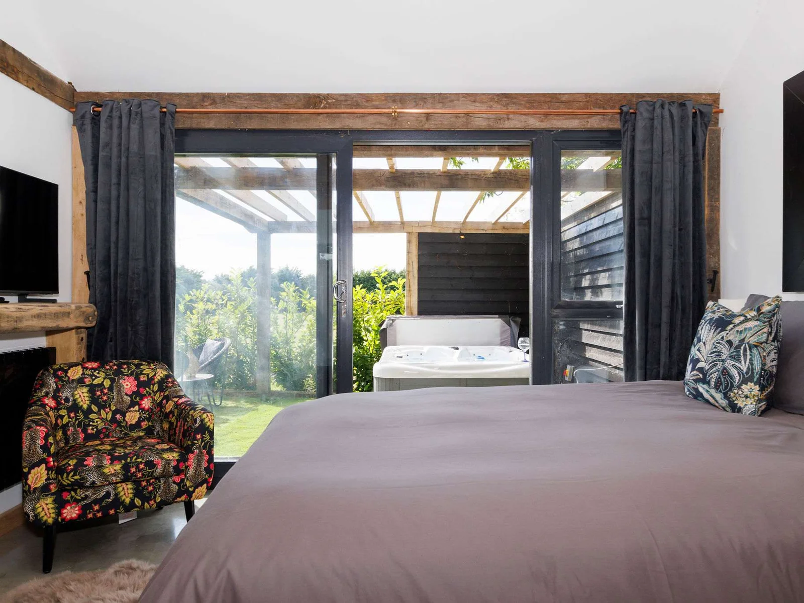 Relax in bed with views out to the courtyard and fields beyond.