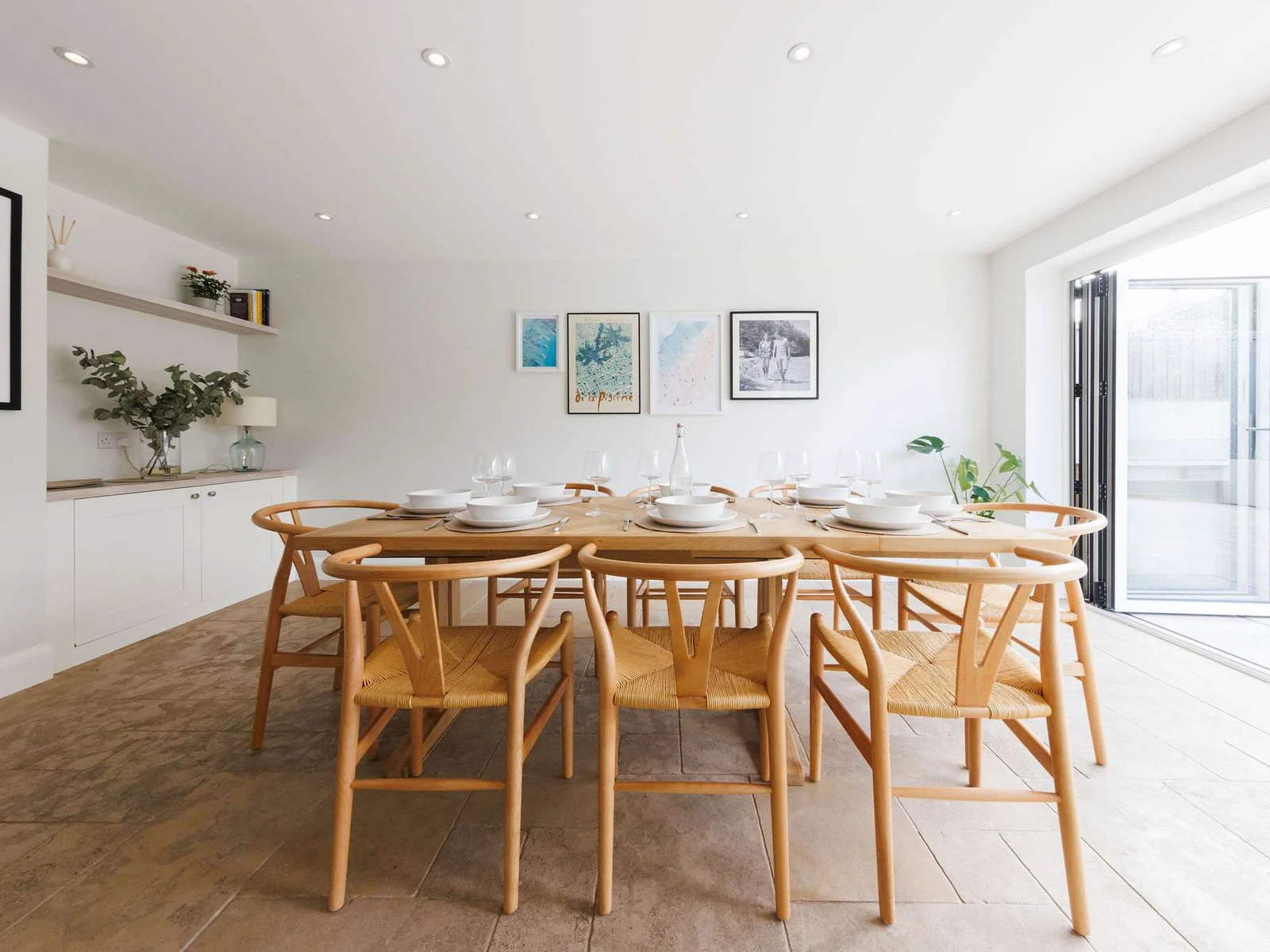 A modern dining table with wishbone chairs.