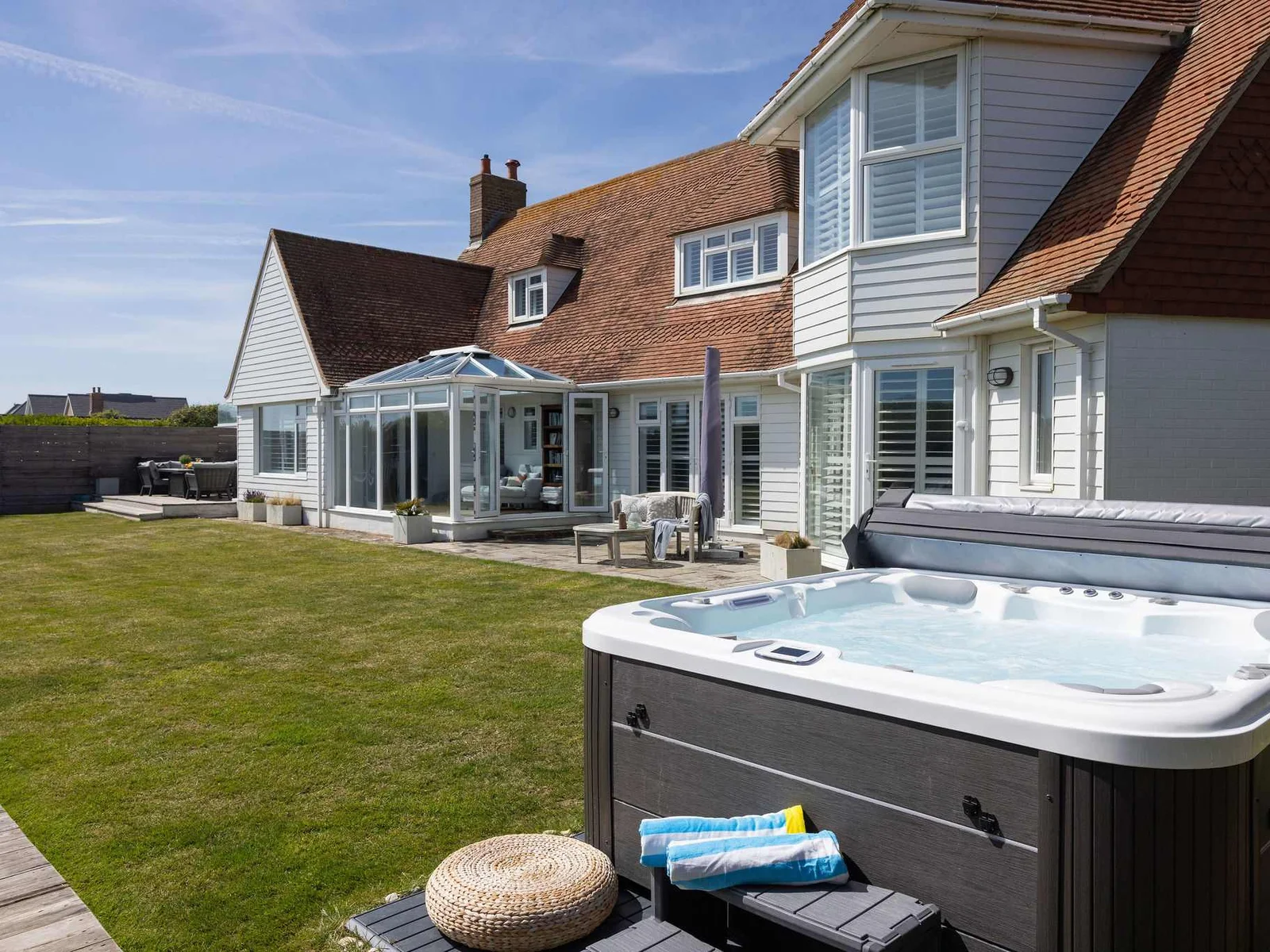 Seafront garden with hot tub & sun deck.