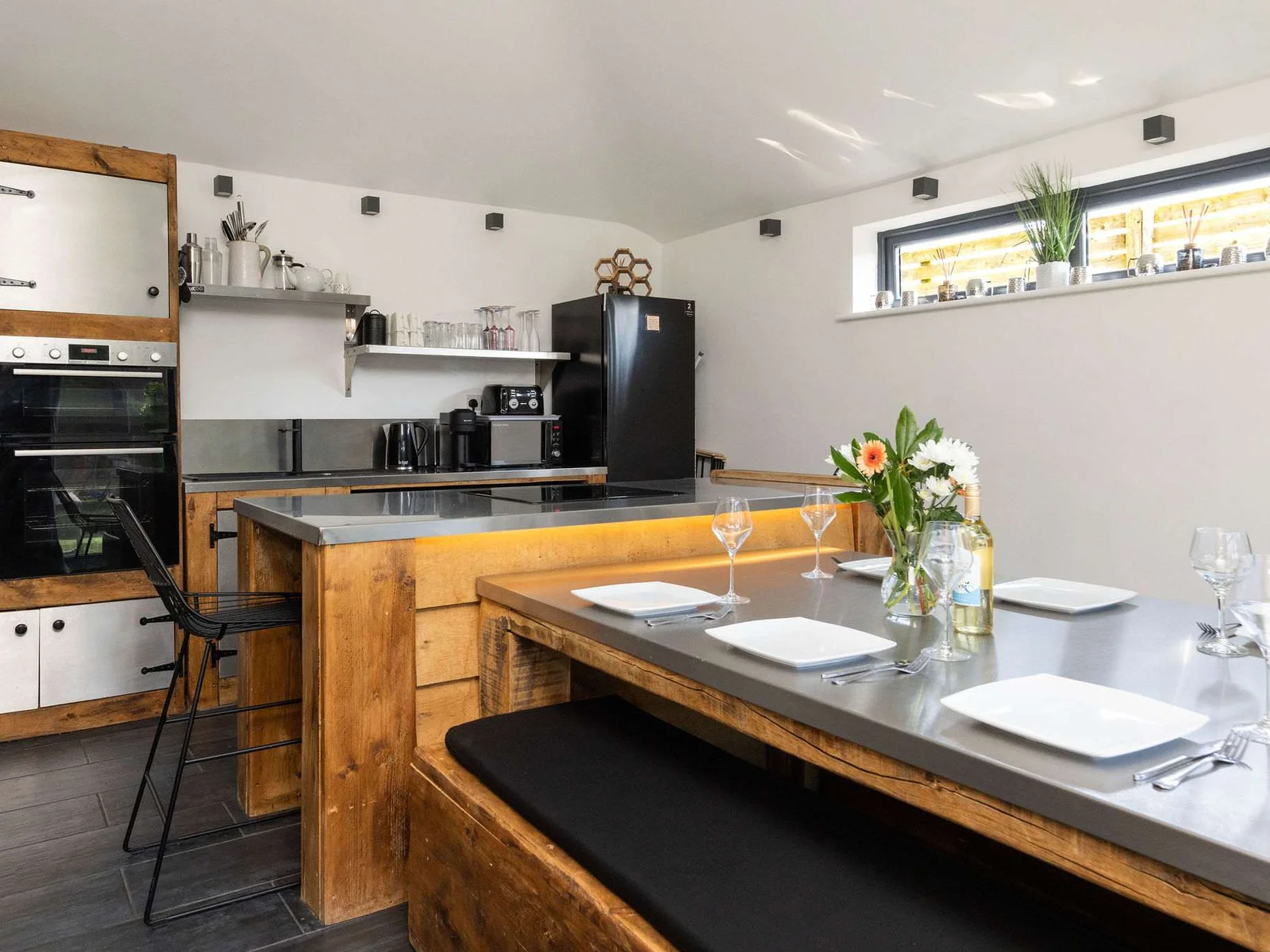 Prepare delicious meals and gather together in this fully-equipped, modern rustic kitchen space.