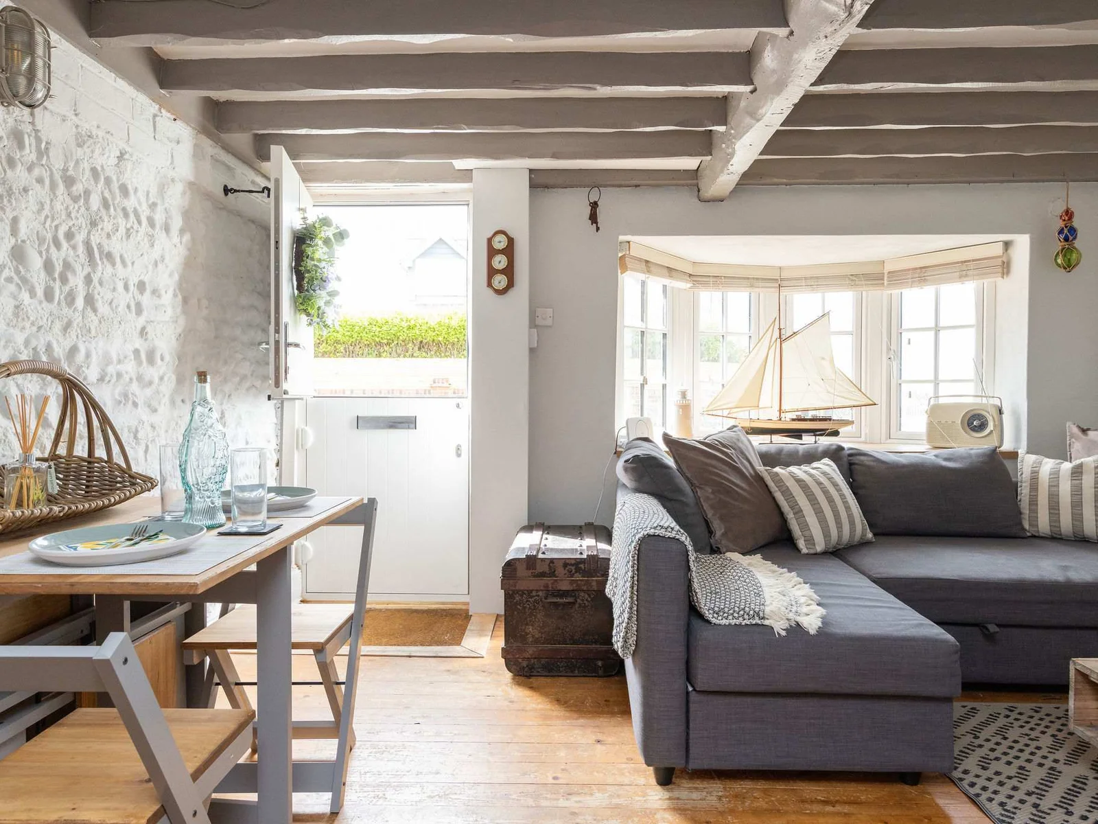 Tucked along the sought-after Shore Road, the house blends original features like exposed beams and flint walls with tasteful modern comforts.