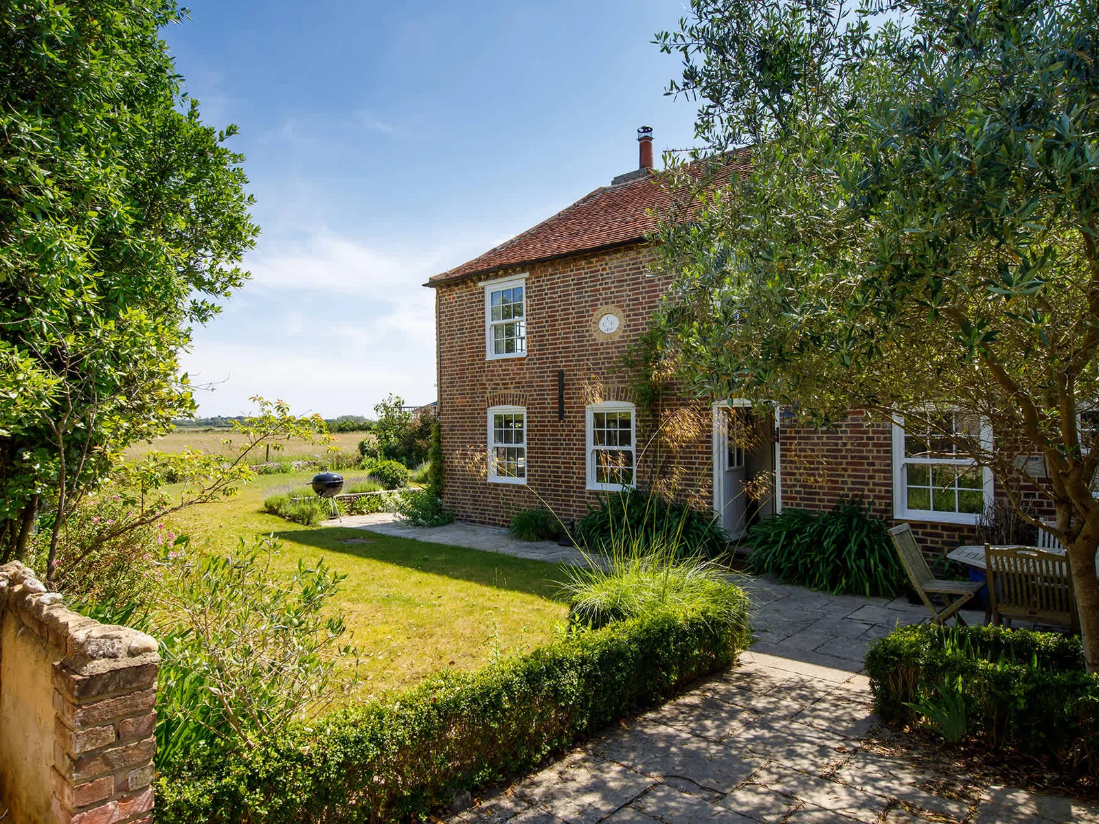 The beautiful cottage, with the sea in the distance