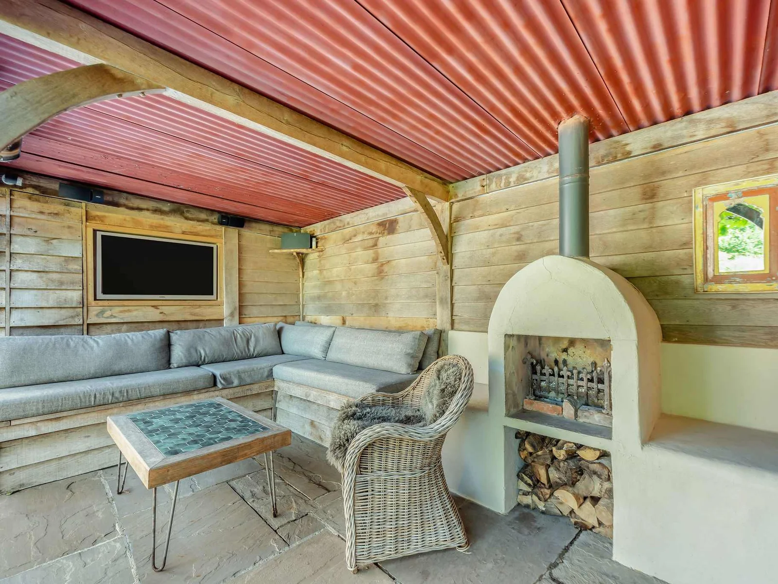 A cosy poolside lounge with fireplace and TV