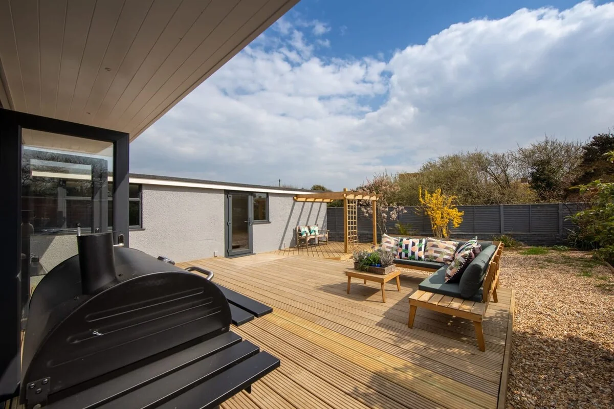 The backyard is surrounded by a tall fence for added privacy