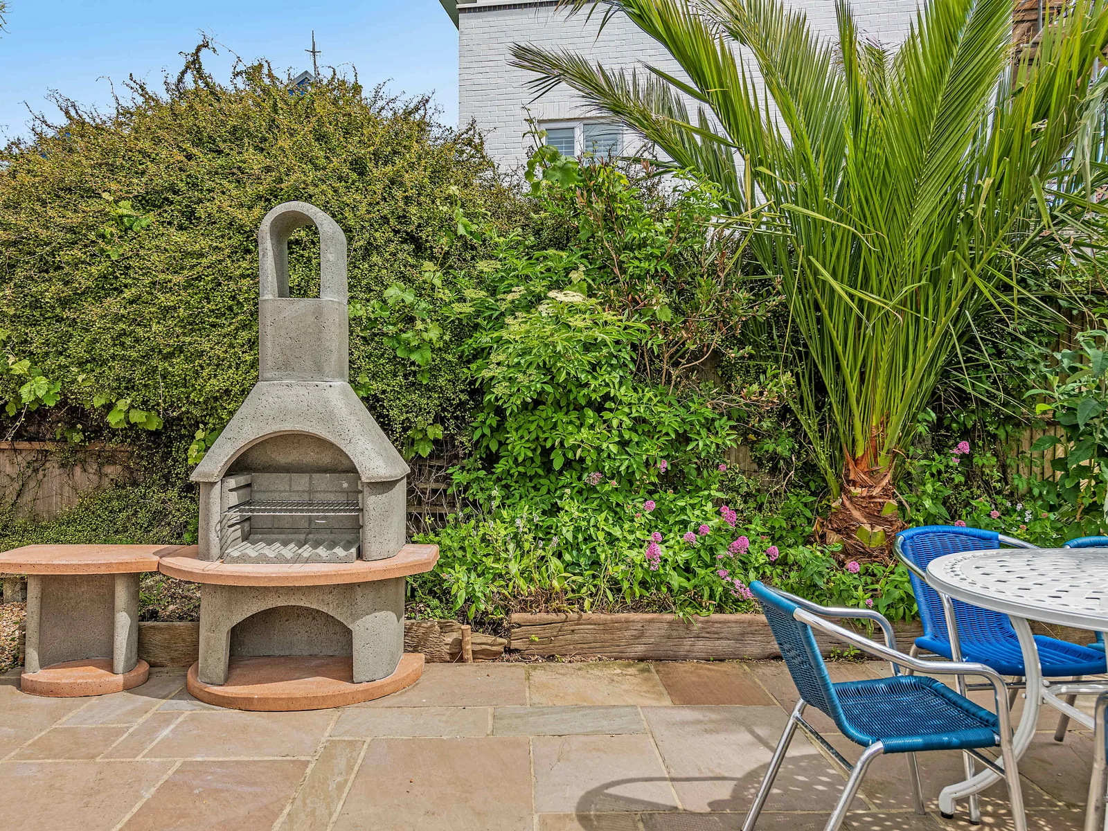 Indispensable outdoor amenities include an inviting seating area with stone BBQ