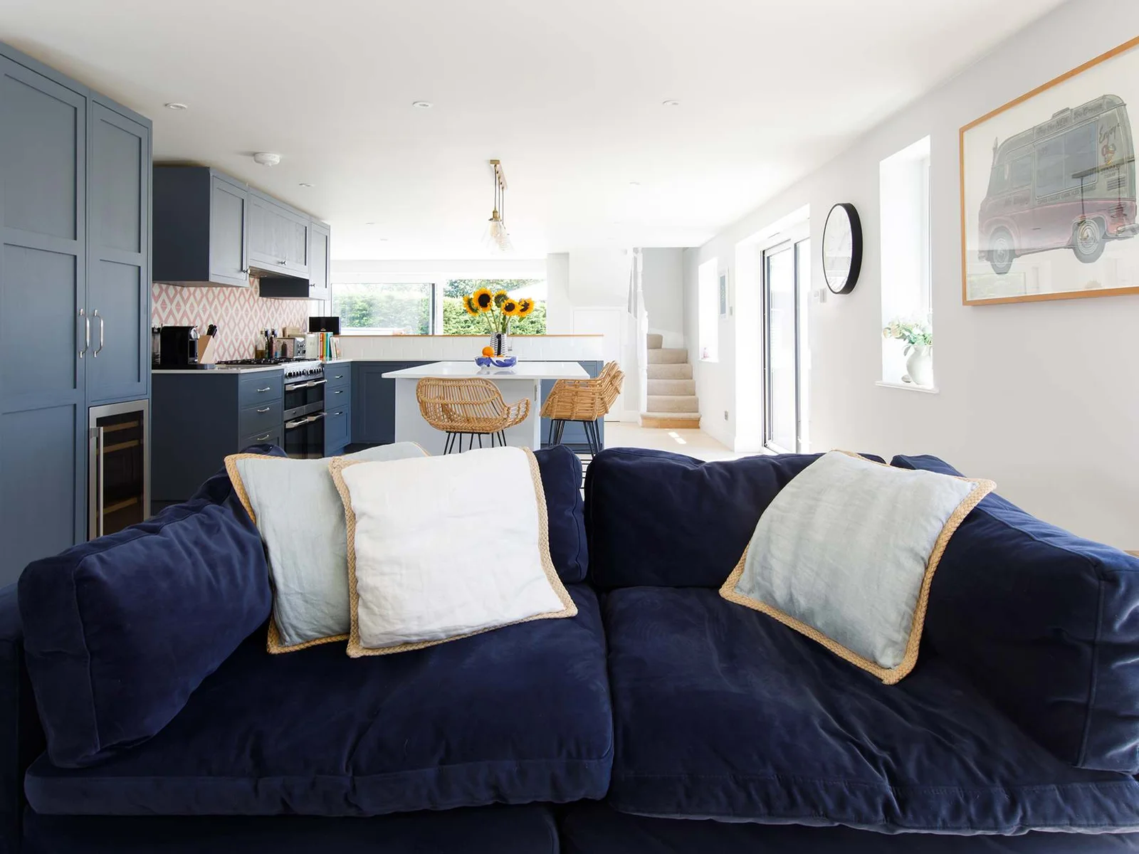 Luxurious sofa and pillows in the kitchen/living space.