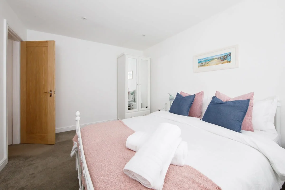 Spacious bedroom with king-size bed and wardrobe.