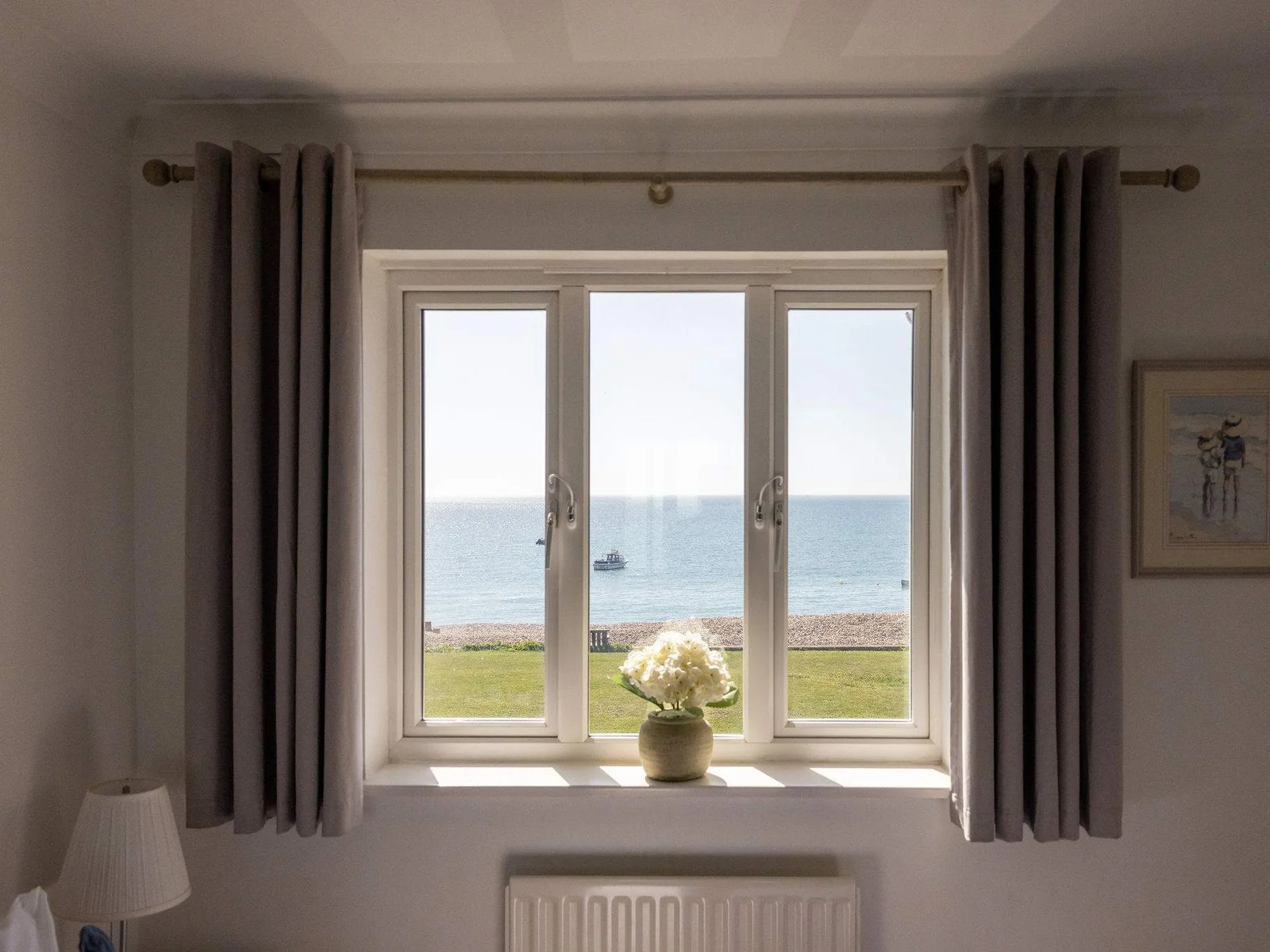 Wake up to panoramic ocean views from this peaceful beachfront holiday home bedroom.