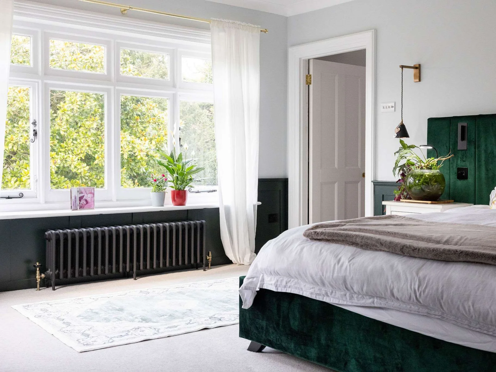The grand master suite with a green velvet emporer bed and garden views