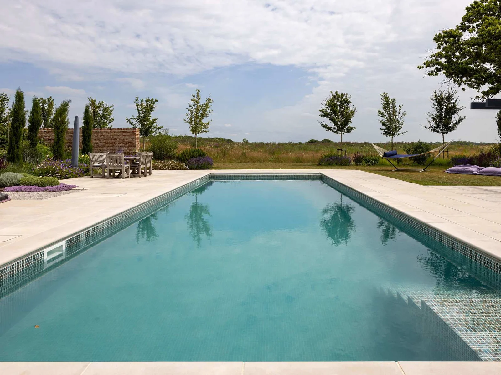 Take a dip in the heated pool surrounded by wildflower meadows and beautifully landscaped gardens