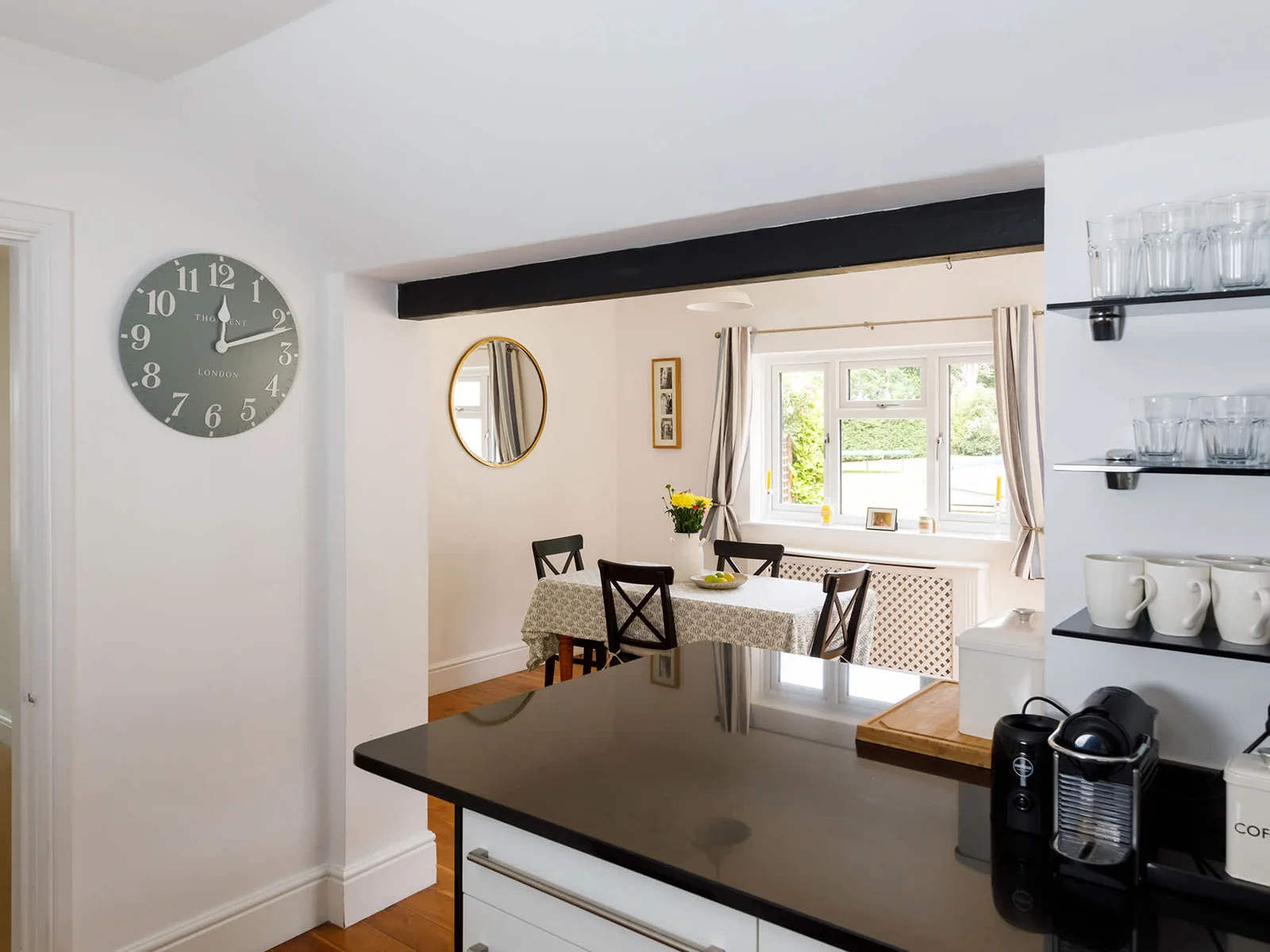 The fully-equipped kitchen looks out over the rear garden and pool.