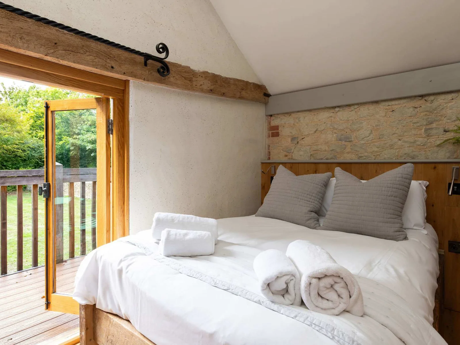 Garden views from bedroom 2 in the Hay Barn, with an en-suite just steps from the bed.