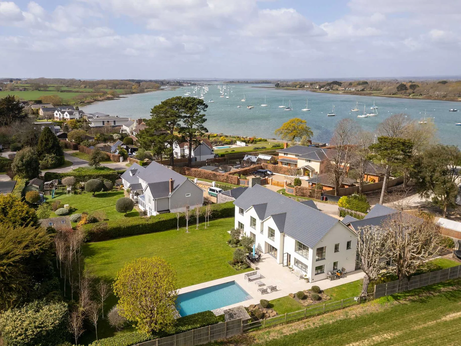 Proudly set along Chichester Harbour with pool, gardens, and stunning waterside views all around.
