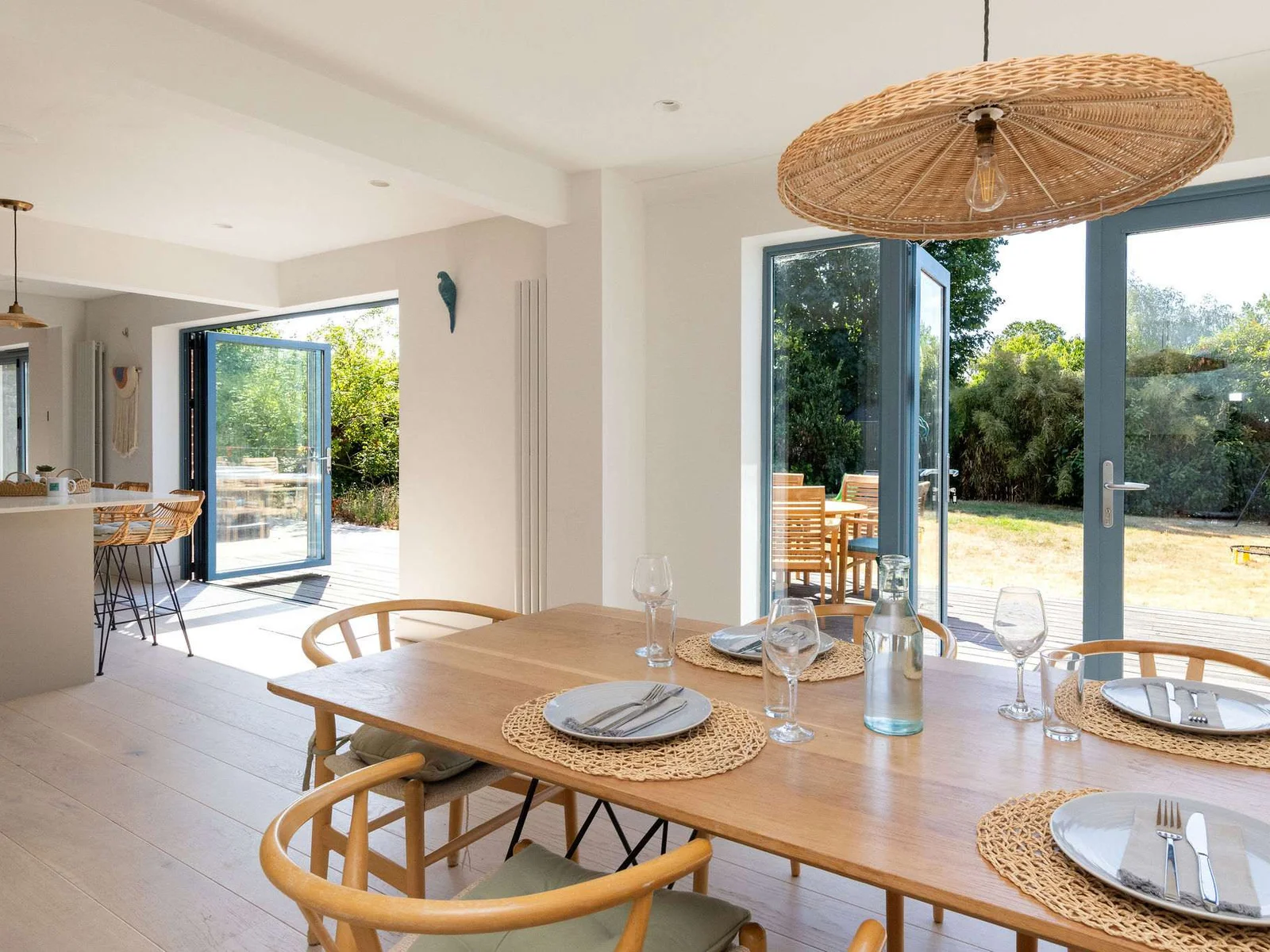 The dining area sits naturally alongside the kitchen, creating an open, sociable layout with bi-fold doors bringing in plenty of light and opening the whole space out to the garden.