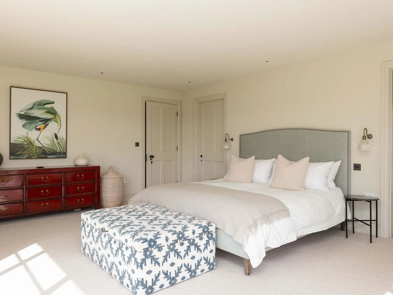 Beautifully styled bedroom blending comfort and character with quality furnishings and curated artwork.