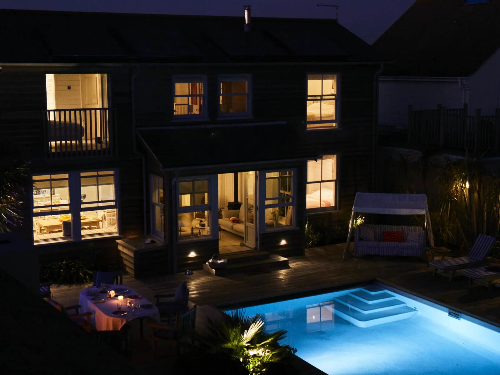 Relax by the pool and enjoy the serene evening ambiance at our stunning seafront property