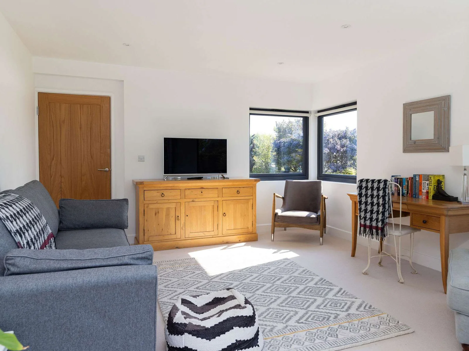 The living room has comfy seating and a smart TV for relaxing evenings.