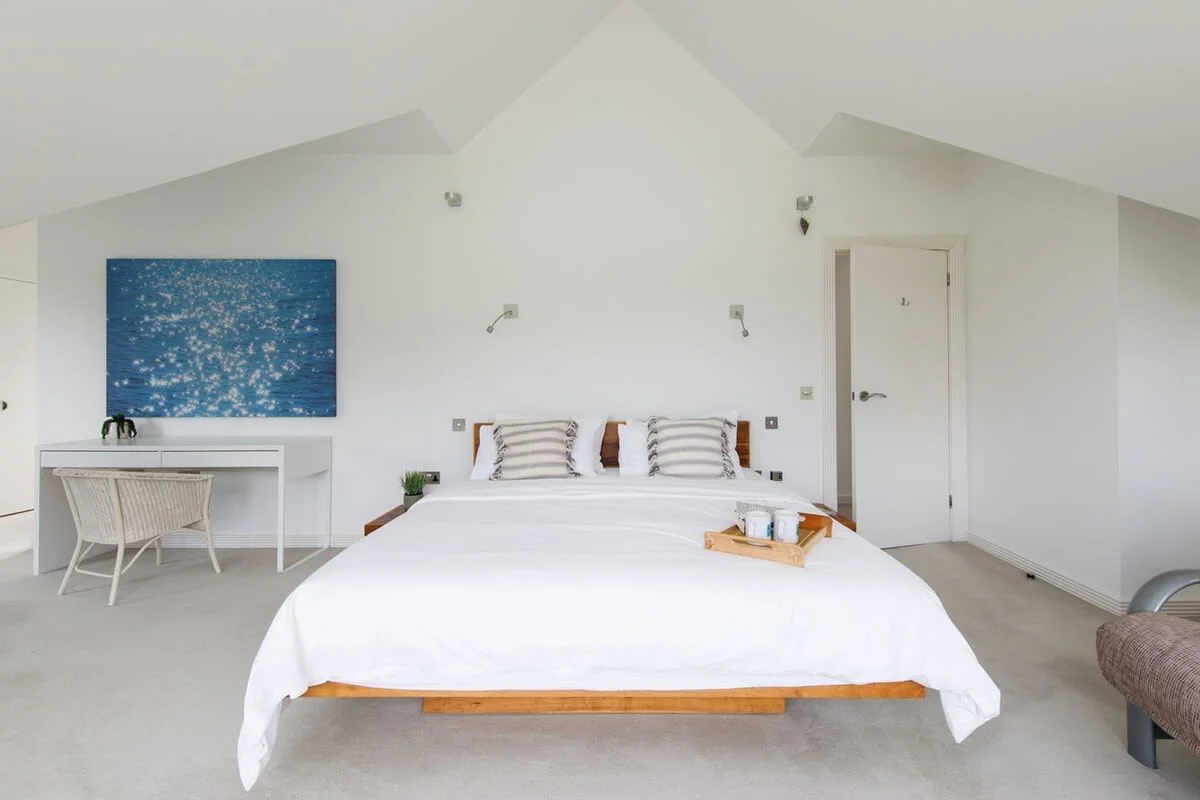 The master bedroom has a walk-in shower and steps up to a luxury bath.