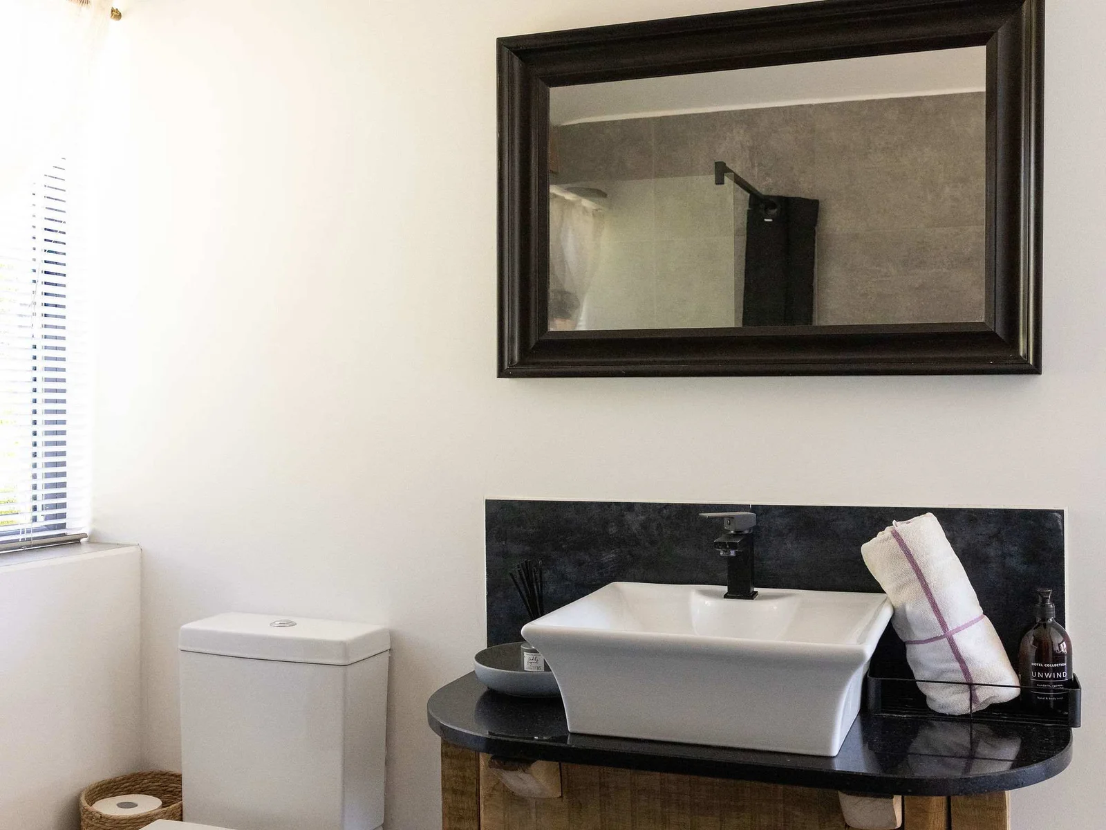 Refresh in this modern bathroom featuring sleek fixtures and stylish rustic wooden details.