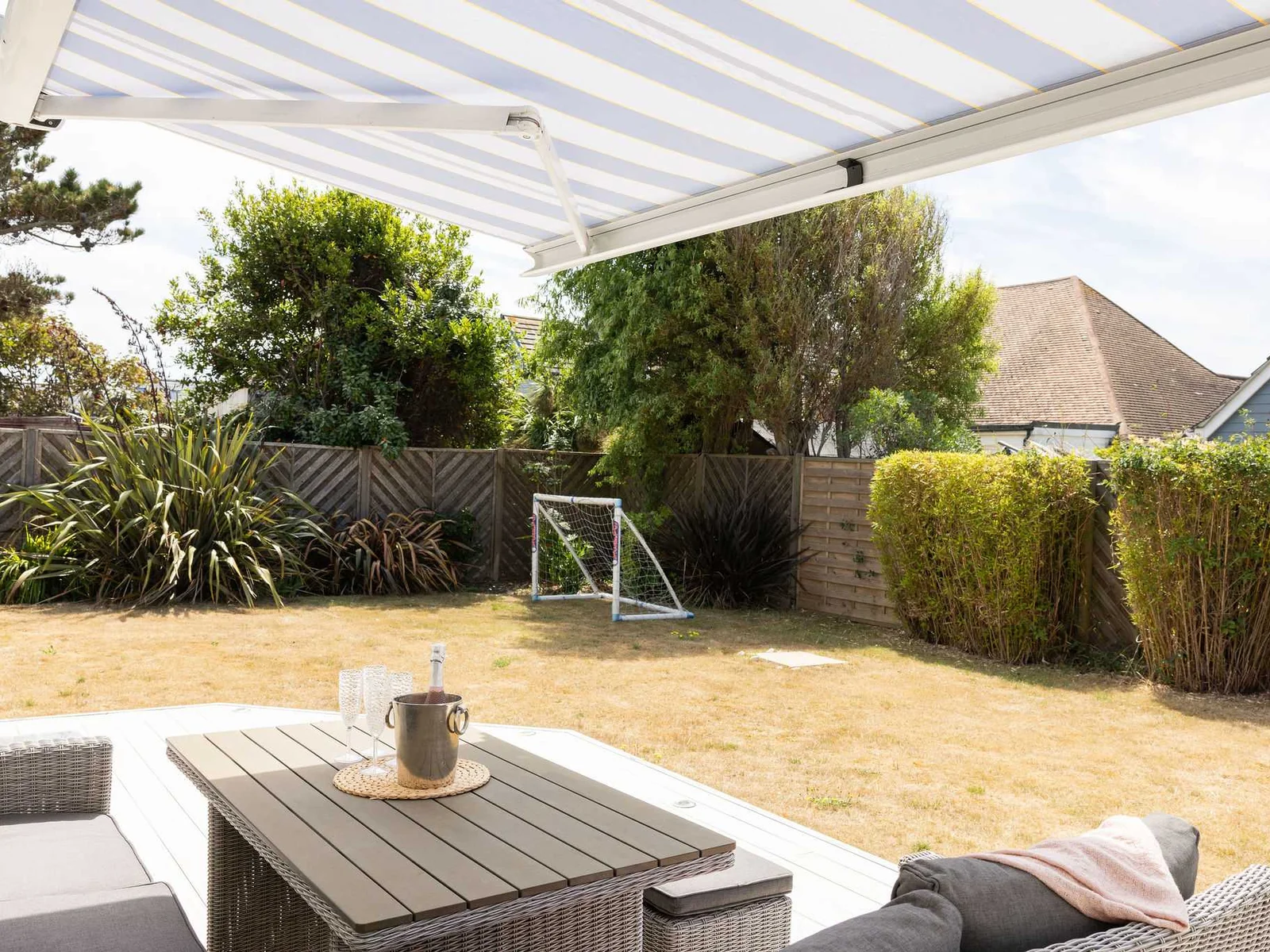 Relax in the shade under the awning with garden views and a couple of goals for the kids