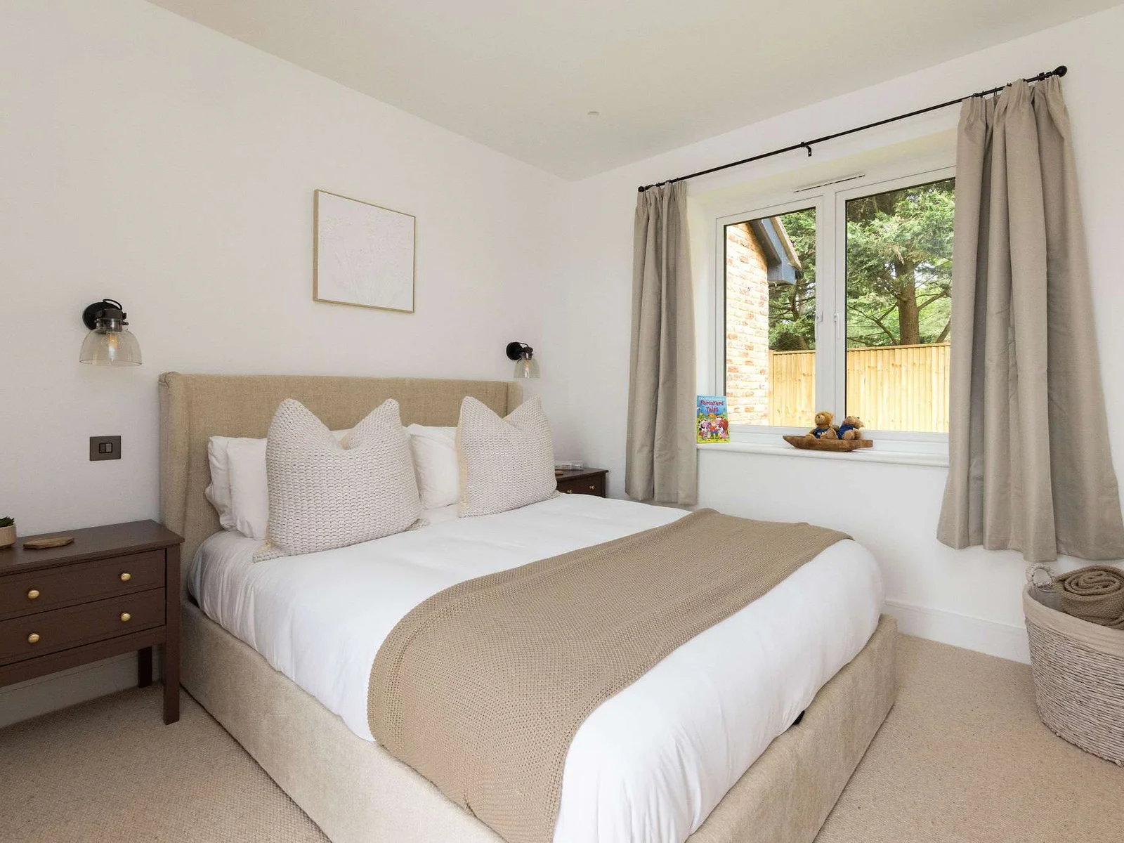 Comfortable bedroom with natural light and garden views