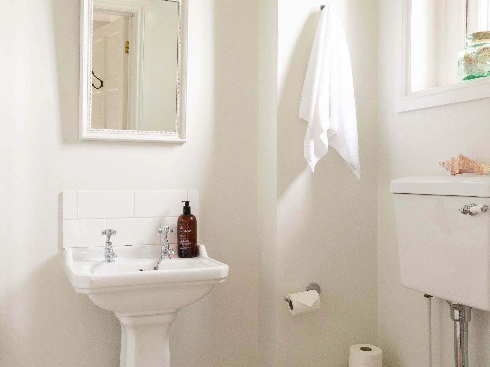 Bright ensuite bathroom with clean and simple styling.