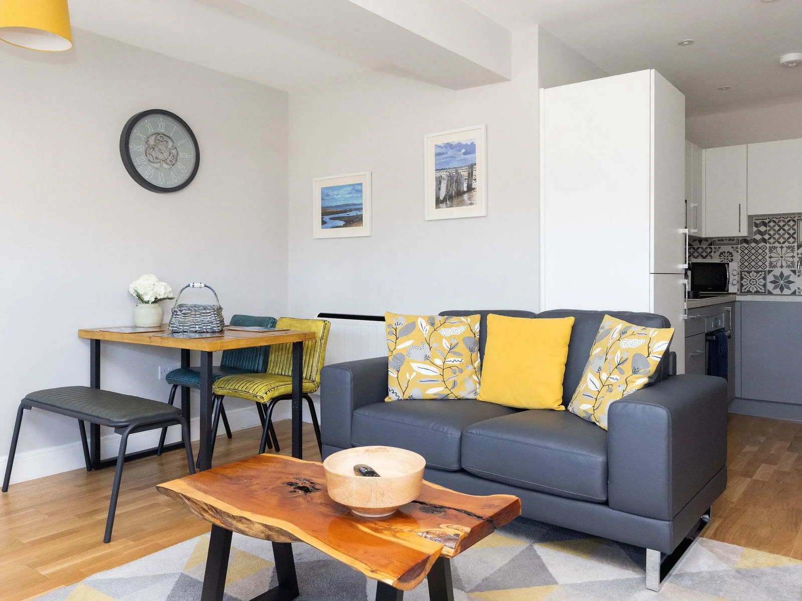 Stylish open-plan living space combining lounge, dining area and modern fully equipped kitchen